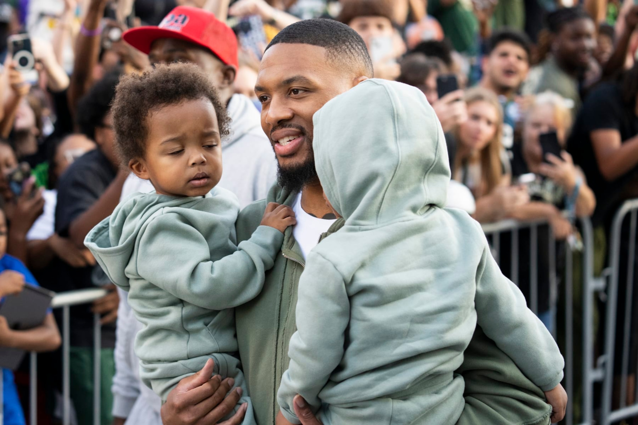 MILWAUKEE, WISCONSIN - SEPTEMBER 30: Damian Lillard walks with his kids during a welcome rally at Fiserv Forum on September 30, 2023 in Milwaukee, Wisconsin. NOTE TO USER: User expressly acknowledges and agrees that, by downloading and or using this photograph, User is consenting to the terms and conditions of the Getty Images License Agreement.(Photo by Patrick McDermott/Getty Images)