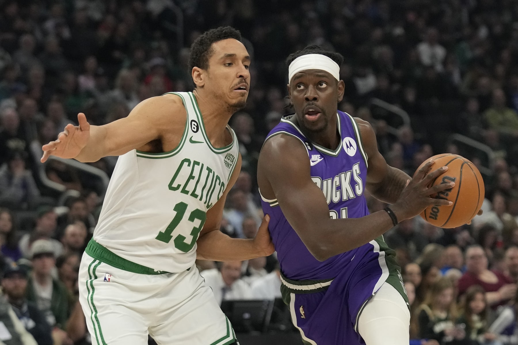 MILWAUKEE, WISCONSIN - MARCH 30: Jrue Holiday #21 of the Milwaukee Bucks dribbles the ball against Malcolm Brogdon #13 of the Boston Celtics in the first half at Fiserv Forum on March 30, 2023 in Milwaukee, Wisconsin. NOTE TO USER: User expressly acknowledges and agrees that, by downloading and or using this photograph, user is consenting to the terms and conditions of the Getty Images License Agreement. (Photo by Patrick McDermott/Getty Images)