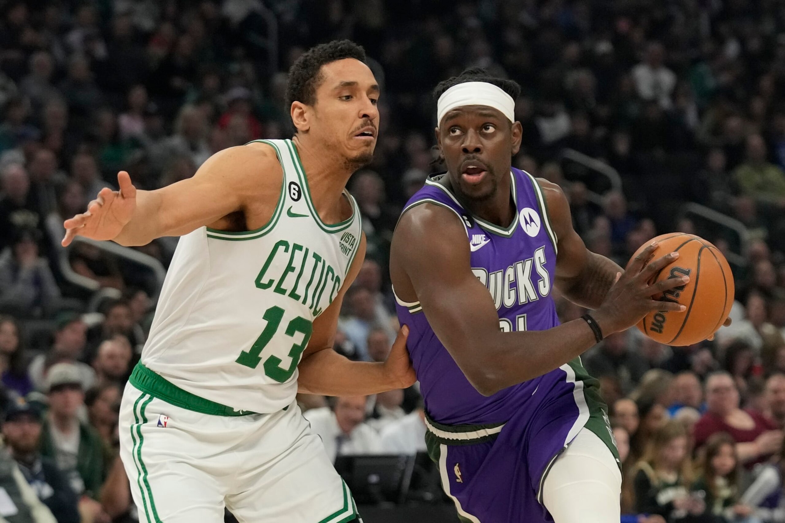 MILWAUKEE, WISCONSIN - MARCH 30: Jrue Holiday #21 of the Milwaukee Bucks dribbles the ball against Malcolm Brogdon #13 of the Boston Celtics in the first half at Fiserv Forum on March 30, 2023 in Milwaukee, Wisconsin. NOTE TO USER: User expressly acknowledges and agrees that, by downloading and or using this photograph, user is consenting to the terms and conditions of the Getty Images License Agreement. (Photo by Patrick McDermott/Getty Images)