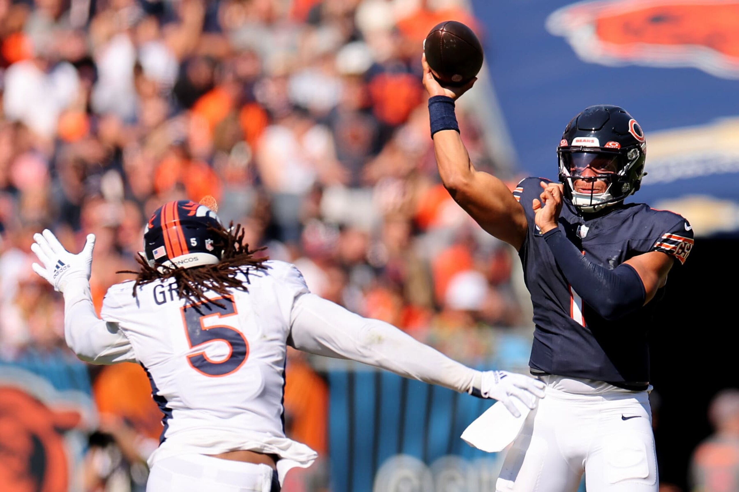 CHICAGO, ILLINOIS - OCTOBER 01: Justin Fields #1 of the Chicago Bears passes the ball over Randy Gregory #5 of the Denver Broncos at Soldier Field on October 01, 2023 in Chicago, Illinois. (Photo by Michael Reaves/Getty Images)