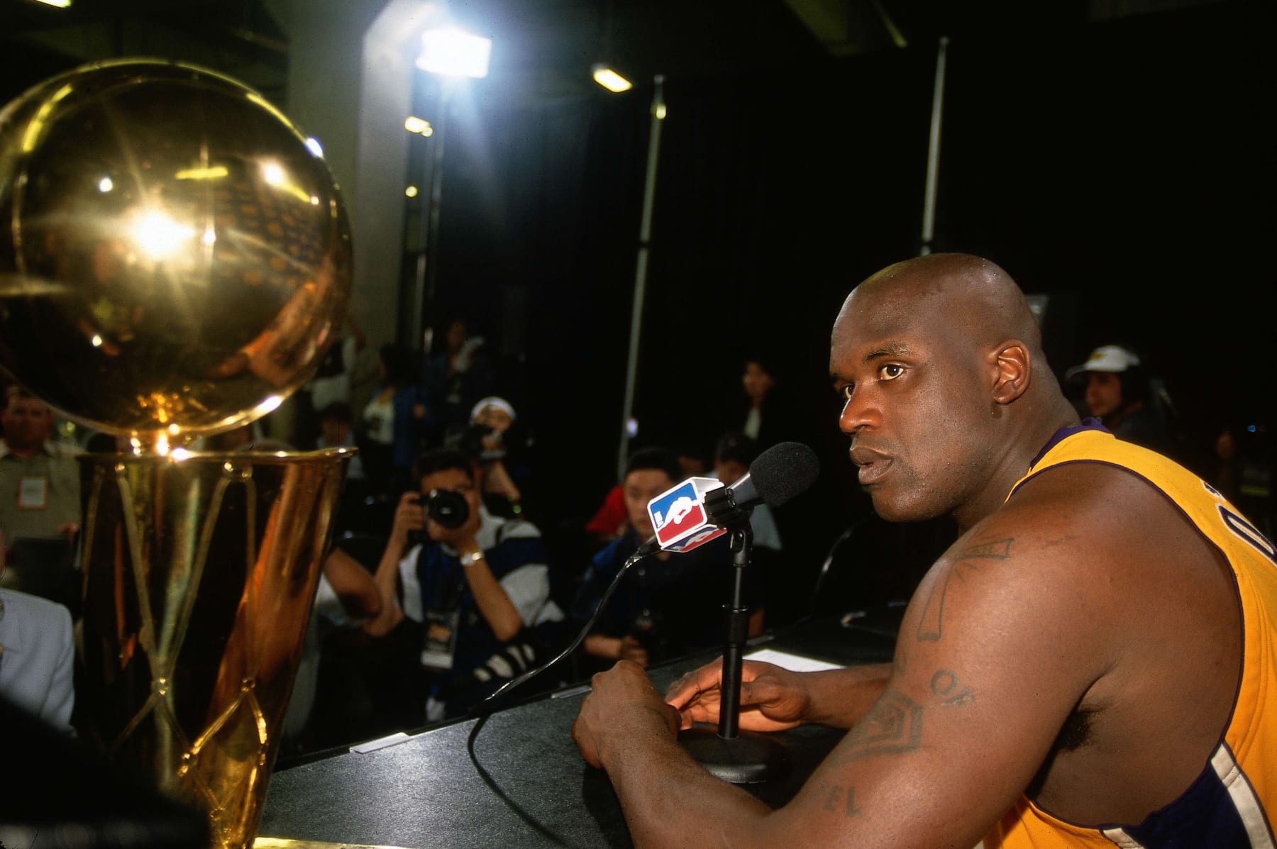 LOS ANGELES - JUNE 19:  Shaquille O'Neal #34 of the Los Angeles Lakers sits with the NBA Championship trophy and talks to the media after defeating the Indiana Pacers in Game Six of the 2000 NBA Finals on June 19, 2000 at the Staples Center in Los Angeles, California. NOTE TO USER: User expressly acknowledges that, by downloading and or using this photograph, User is consenting to the terms and conditions of the Getty Images License agreement. Mandatory Copyright Notice: Copyright 2000 NBAE (Photo by Nathaniel S. Butler/NBAE via Getty Images)