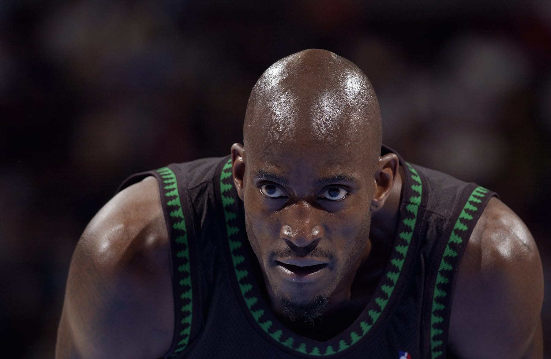 DENVER - MARCH 24:  Kevin Garnett #21 of the Minnesota Timberwolves leans over during the game against the Denver Nuggets at the Pepsi Center on March 26, 2004 in Denver, Colorado.  The Nuggets won 101-925.   NOTE TO USER: User expressly acknowledges and agrees that, by downloading and/or using this Photograph, User is consenting to the terms and conditions of the Getty Images License Agreement.  (Photo by Garrett Ellwood/NBAE via Getty Images)