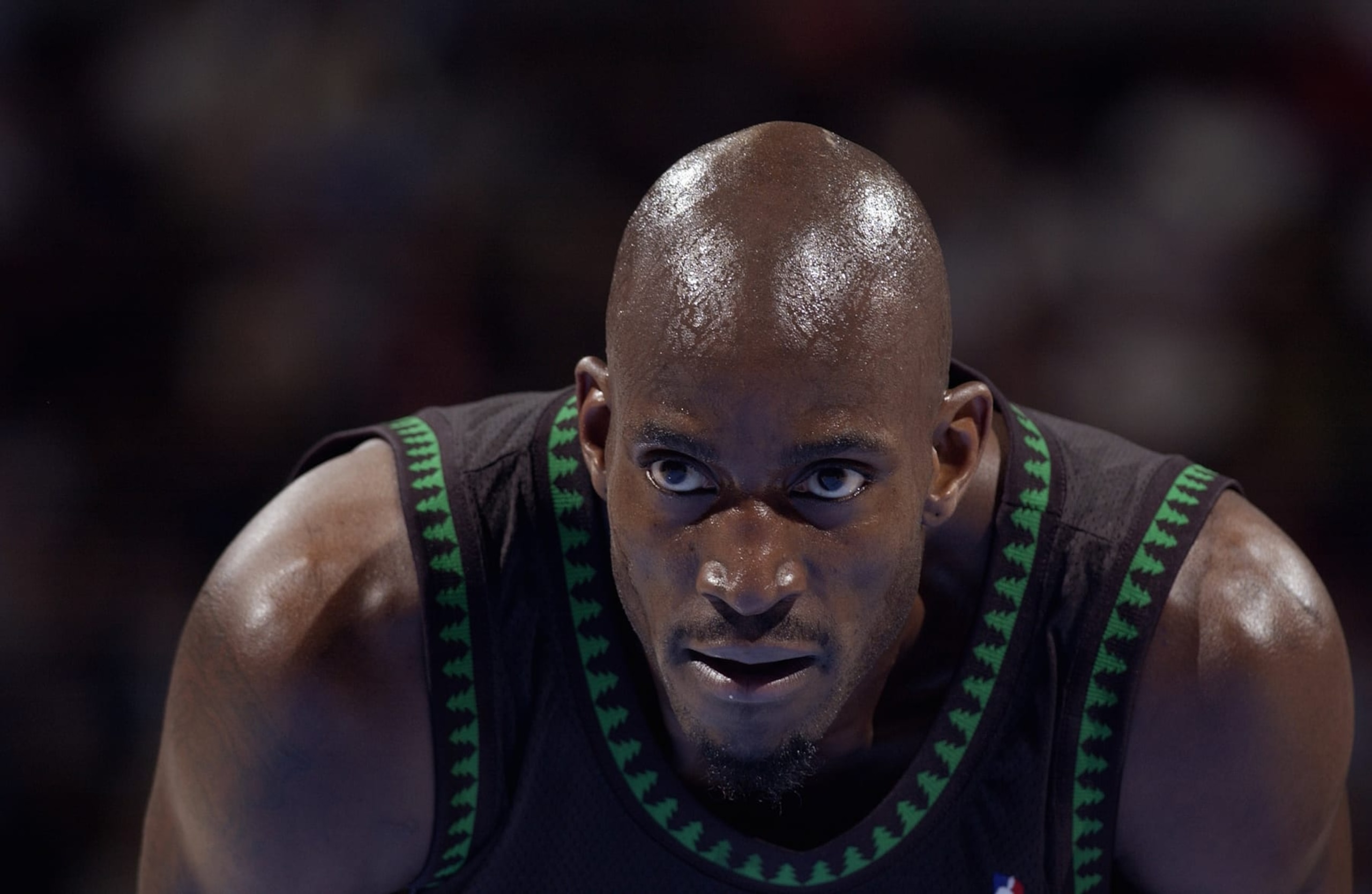 DENVER - MARCH 24:  Kevin Garnett #21 of the Minnesota Timberwolves leans over during the game against the Denver Nuggets at the Pepsi Center on March 26, 2004 in Denver, Colorado.  The Nuggets won 101-925.   NOTE TO USER: User expressly acknowledges and agrees that, by downloading and/or using this Photograph, User is consenting to the terms and conditions of the Getty Images License Agreement.  (Photo by Garrett Ellwood/NBAE via Getty Images)