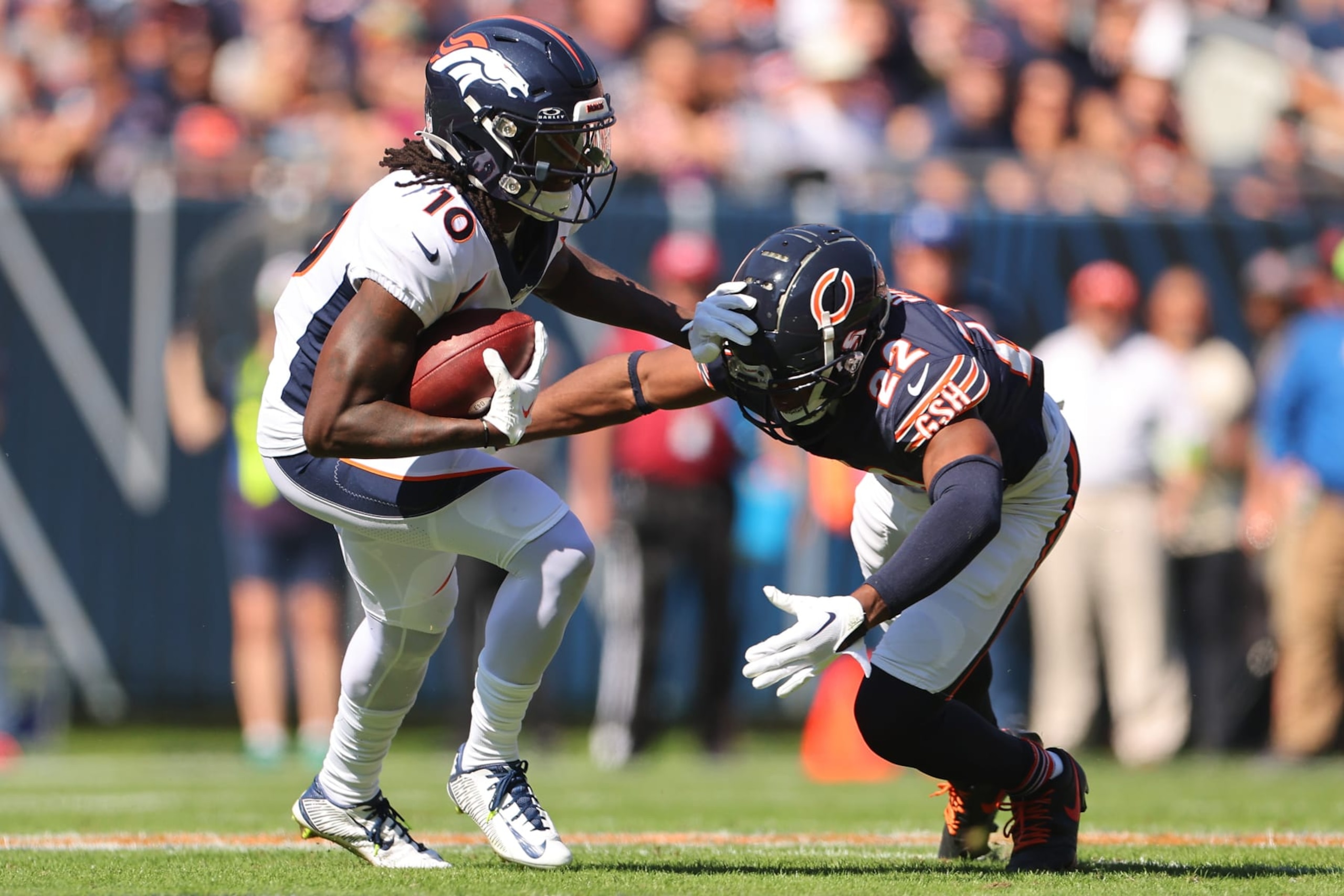CHICAGO, ILLINOIS - OCTOBER 01: Jerry Jeudy #10 of the Denver Broncos stiff arms Elijah Hicks #22 of the Chicago Bears during the first quarter at Soldier Field on October 01, 2023 in Chicago, Illinois. (Photo by Michael Reaves/Getty Images)