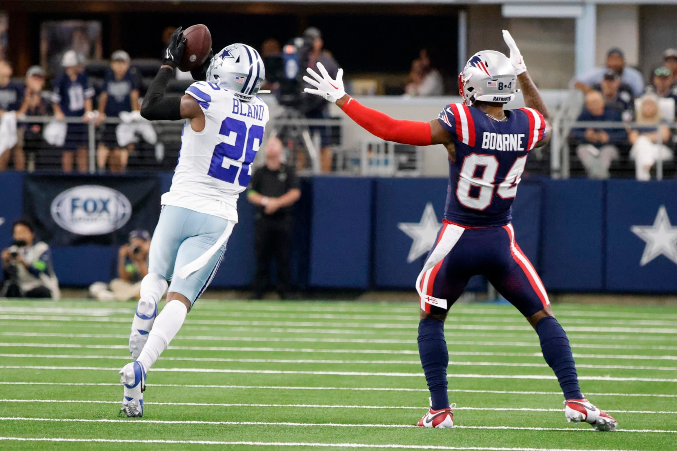 Patriots WR Kendrick Bourne watches Cowboys CB DaRon Bland intercept a pass