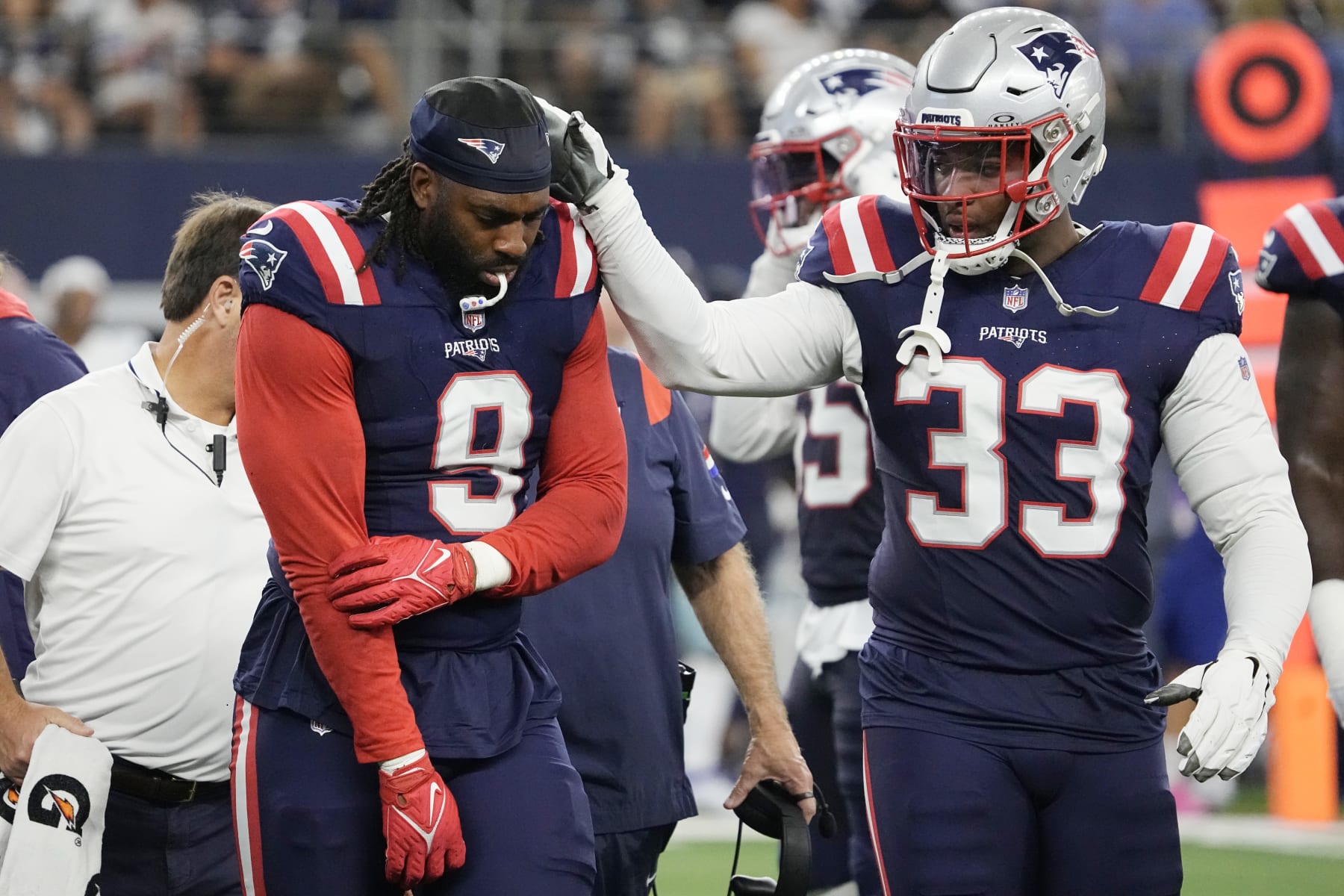 ARLINGTON, TEXAS - OCTOBER 01: Matthew Judon #9 of the New England Patriots holds his arm while walking off the field while consoled by Anfernee Jennings #33 of the New England Patriots during the third quarter against the Dallas Cowboys at AT&T Stadium on October 01, 2023 in Arlington, Texas. (Photo by Sam Hodde/Getty Images)