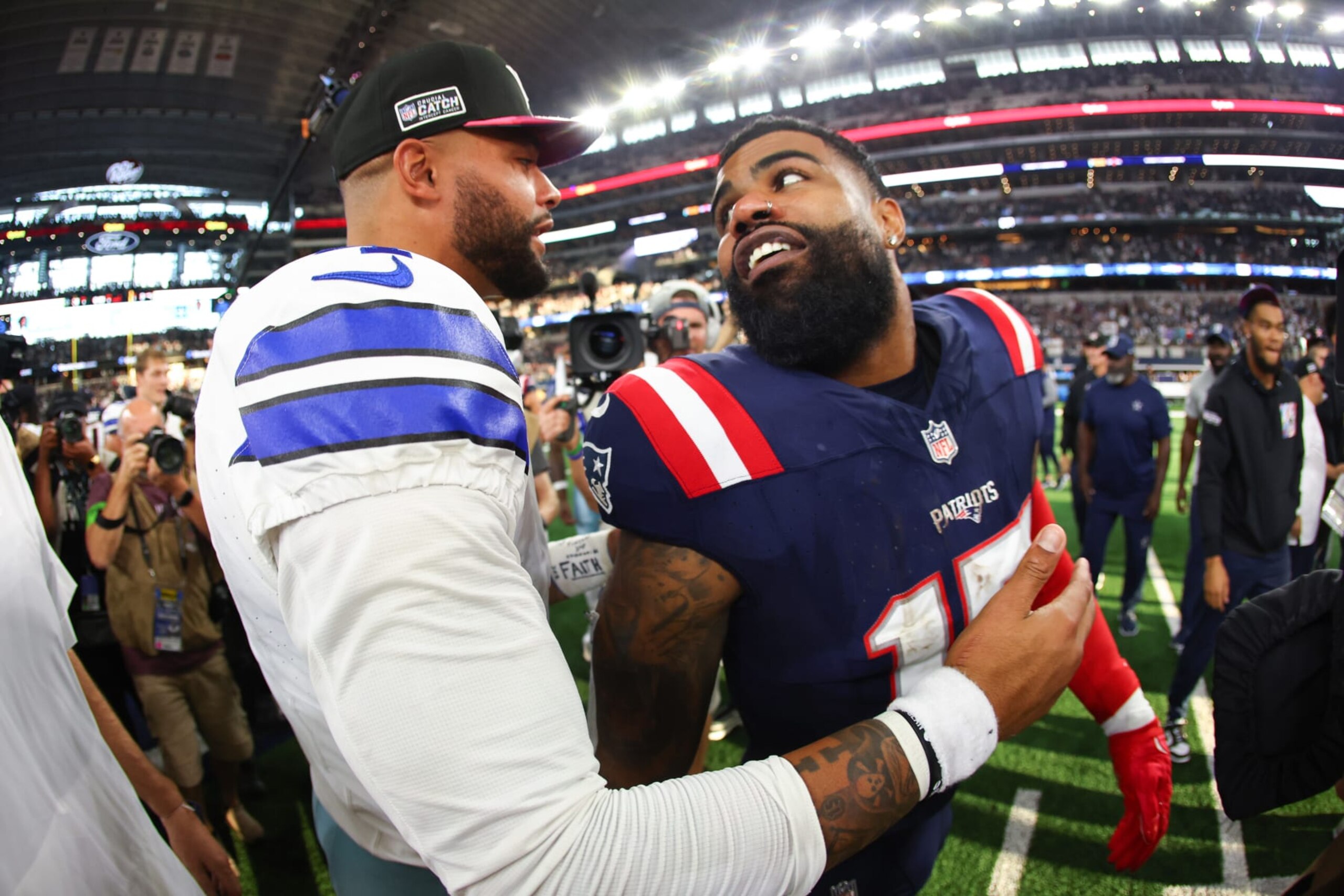 ARLINGTON, TEXAS - OCTOBER 01: Dak Prescott #4 of the Dallas Cowboys and Ezekiel Elliott #15 of the New England Patriots embrace after their game at AT&T Stadium on October 01, 2023 in Arlington, Texas. (Photo by Richard Rodriguez/Getty Images)