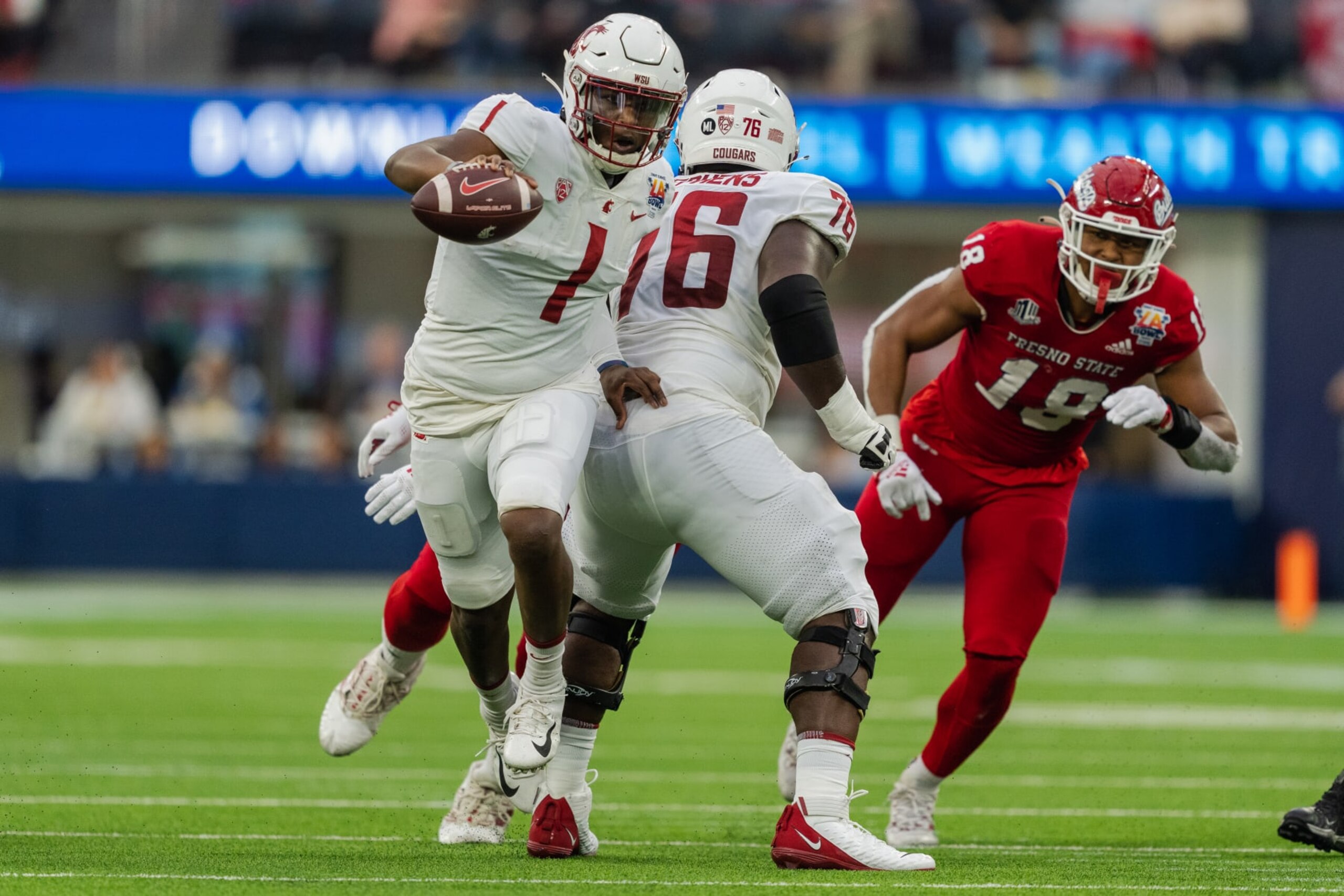 LOS ANGELES, CA - DECEMBER 17: Cameron Ward #1 of Washington State runs out of the pocket while being protected by Grant Stephens #76 of Washington State preparing to block Zeke Branham #19 of Fresno State during the LA Bowl game between Washington State Cougars and Fresno State Bulldogs at SoFi Stadium on December 17, 2022 in Los Angeles, California. (Photo by Jason Allen/ISI Photos/Getty Images)