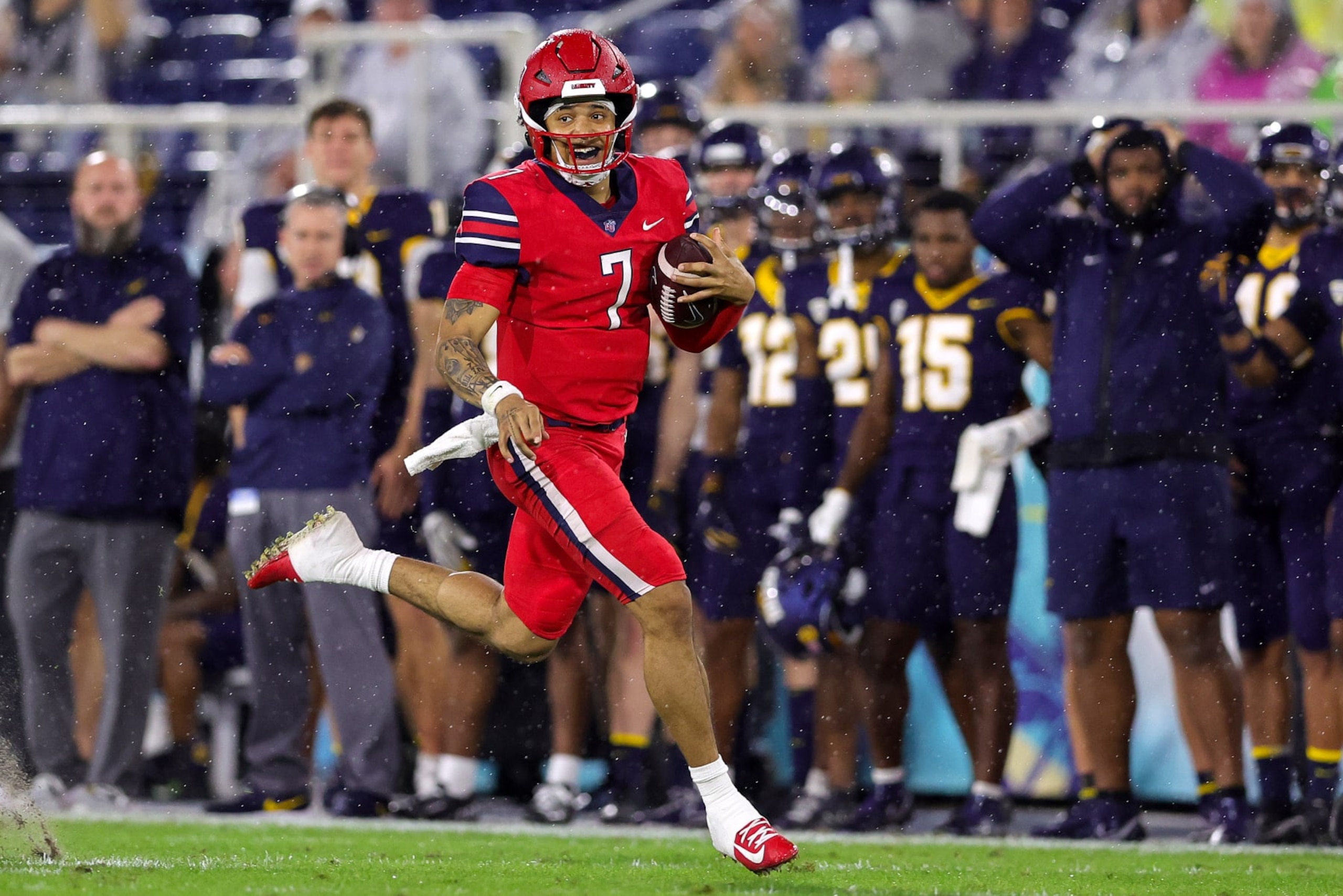 BOCA RATON, FLORIDA - DECEMBER 20: Kaidon Salter #7 of the Liberty Flames carries the ball against the Toledo Rockets during the first half of the RoofClaim.com Boca Raton Bowl game at FAU Stadium on December 20, 2022 in Boca Raton, Florida. (Photo by Megan Briggs/Getty Images)
