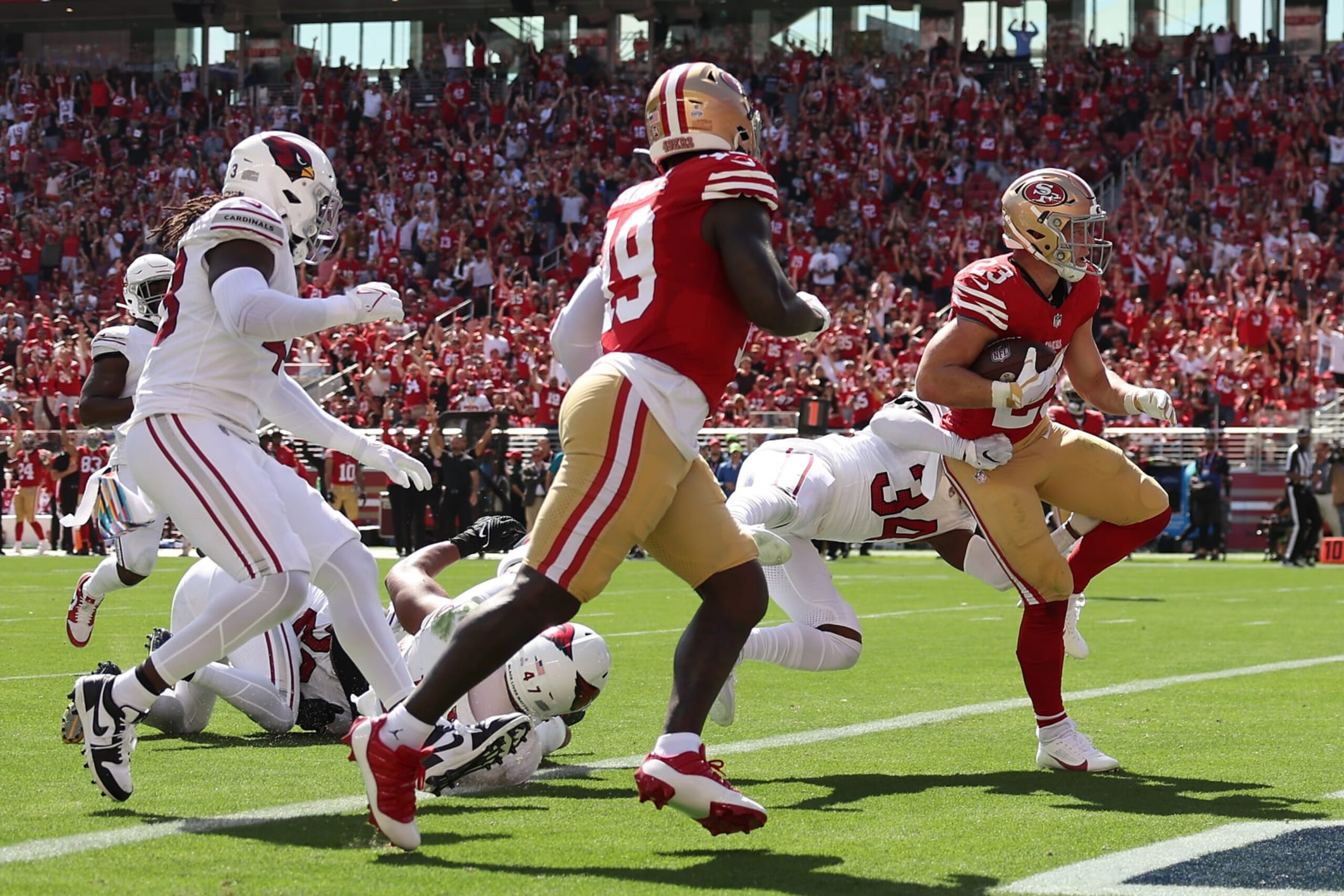 SANTA CLARA, CALIFORNIA - OCTOBER 01: Christian McCaffrey #23 of the San Francisco 49ers runs for a touchdown against the Arizona Cardinals during the second quarter at Levi's Stadium on October 01, 2023 in Santa Clara, California. (Photo by Ezra Shaw/Getty Images)
