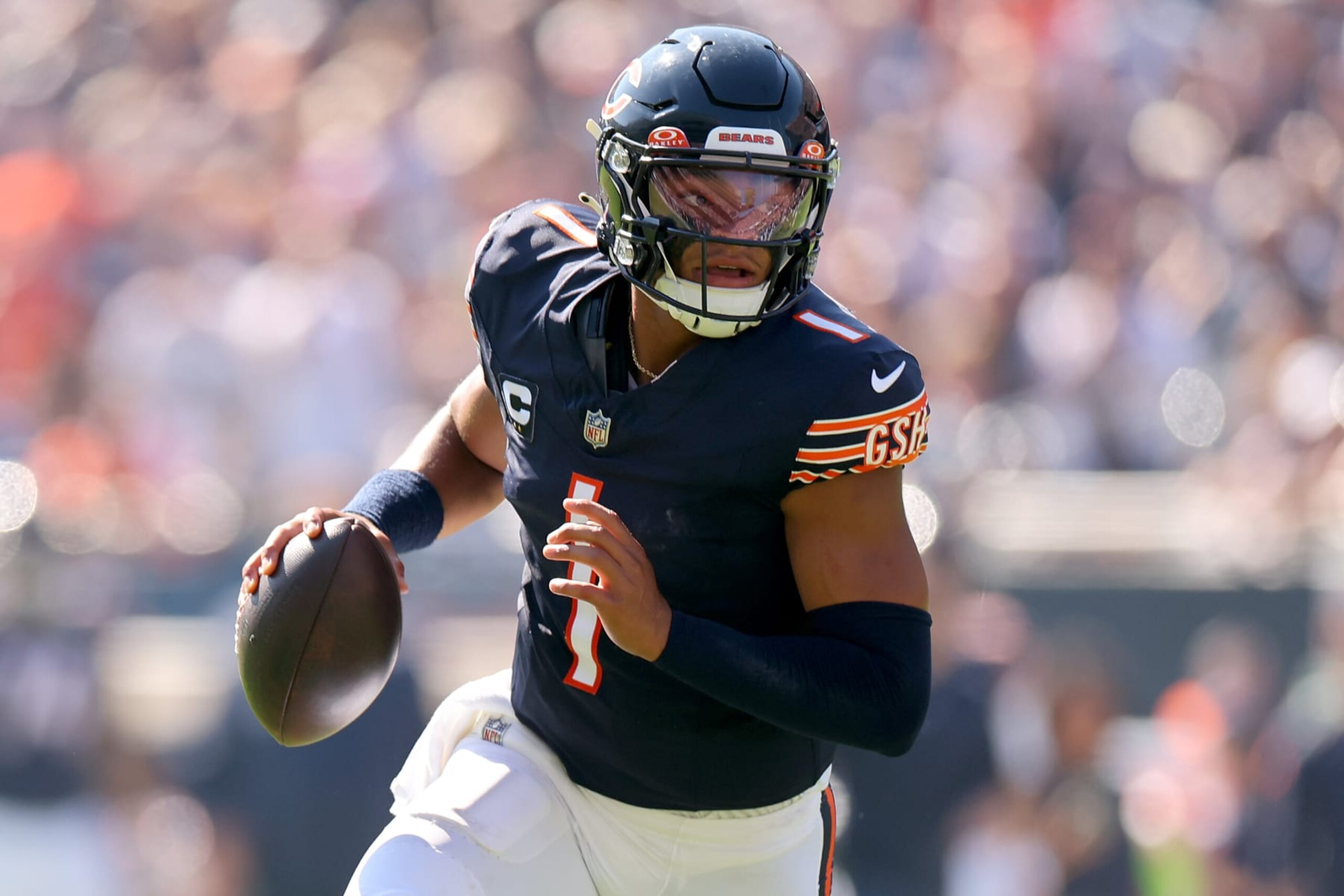 CHICAGO, ILLINOIS - OCTOBER 01: Justin Fields #1 of the Chicago Bears scrambles with the ball against the Denver Broncos during the second quarter at Soldier Field on October 01, 2023 in Chicago, Illinois. (Photo by Michael Reaves/Getty Images)