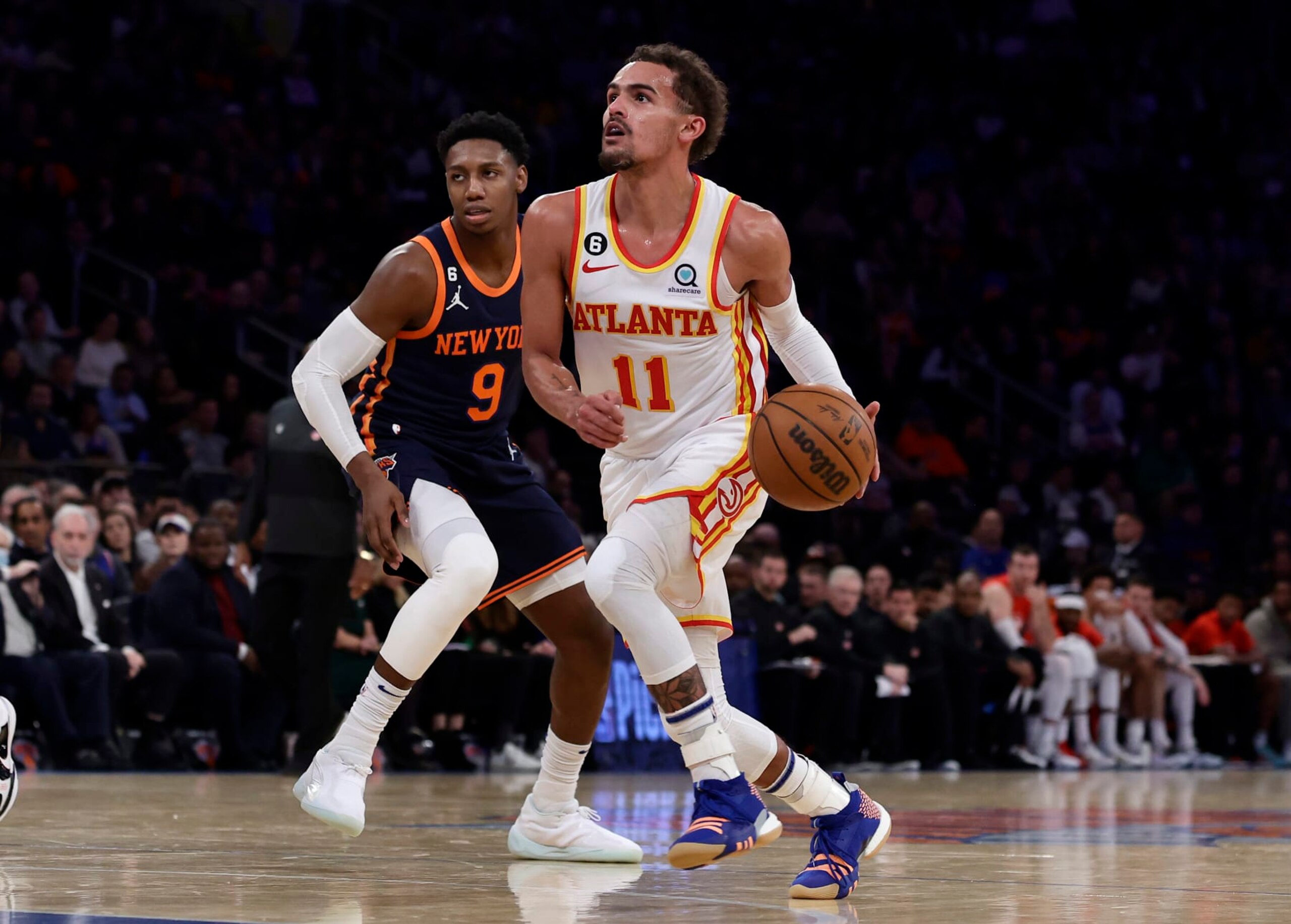 NEW YORK, NEW YORK - DECEMBER 07: (NEW YORK DAILIES OUT)  Trae Young #11 of the Atlanta Hawks in action against RJ Barrett #9 of the New York Knicks at Madison Square Garden on December 07, 2022 in New York City. The Knicks defeated the Hawks 113-89. NOTE TO USER: User expressly acknowledges and agrees that, by downloading and or using this photograph, User is consenting to the terms and conditions of the Getty Images License Agreement. (Photo by Jim McIsaac/Getty Images)