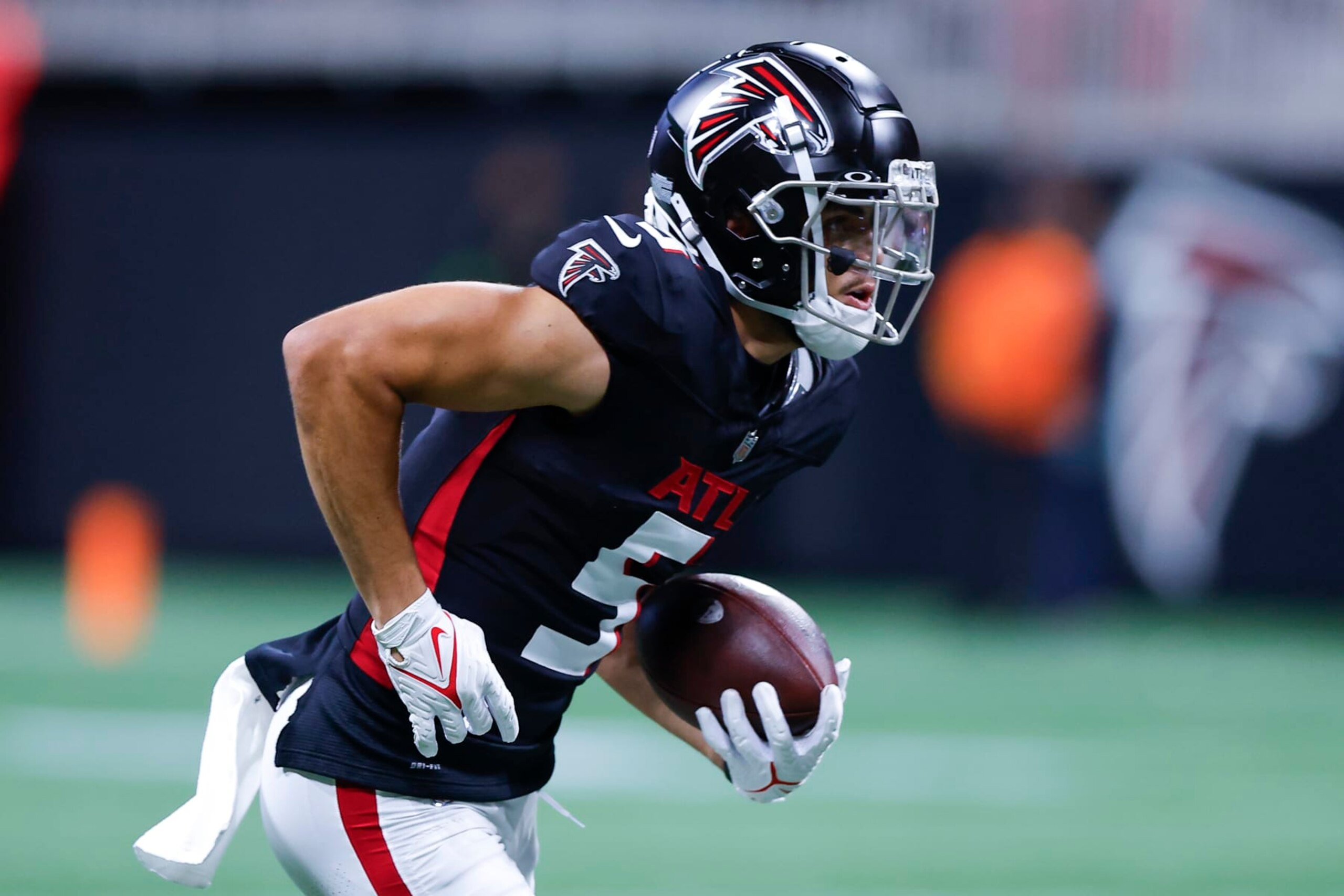ATLANTA, GEORGIA - AUGUST 18: Drake London #5 of the Atlanta Falcons looks for yardage after a reception during the first half of a preseason game against the Cincinnati Bengals at Mercedes-Benz Stadium on August 18, 2023 in Atlanta, Georgia. (Photo by Todd Kirkland/Getty Images)