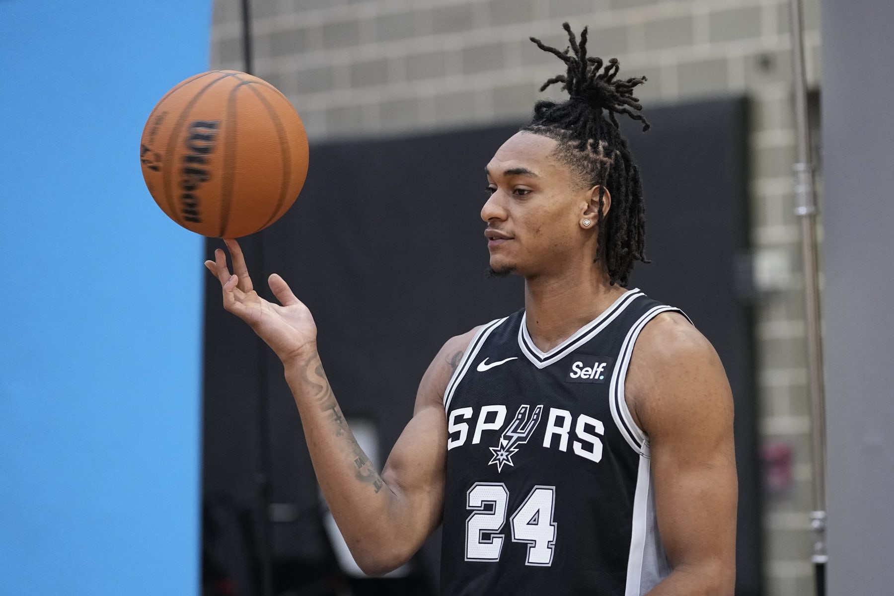 San Antonio Spurs guard Devin Vassell (24) poses for photos during an NBA basketball media day in San Antonio, Monday, Oct. 2, 2023. (AP Photo/Eric Gay)