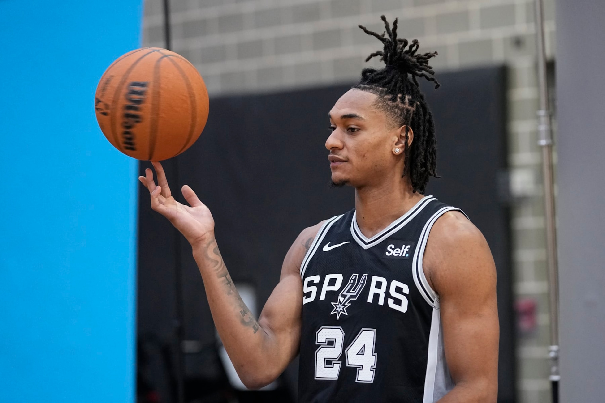 San Antonio Spurs guard Devin Vassell (24) poses for photos during an NBA basketball media day in San Antonio, Monday, Oct. 2, 2023. (AP Photo/Eric Gay)
