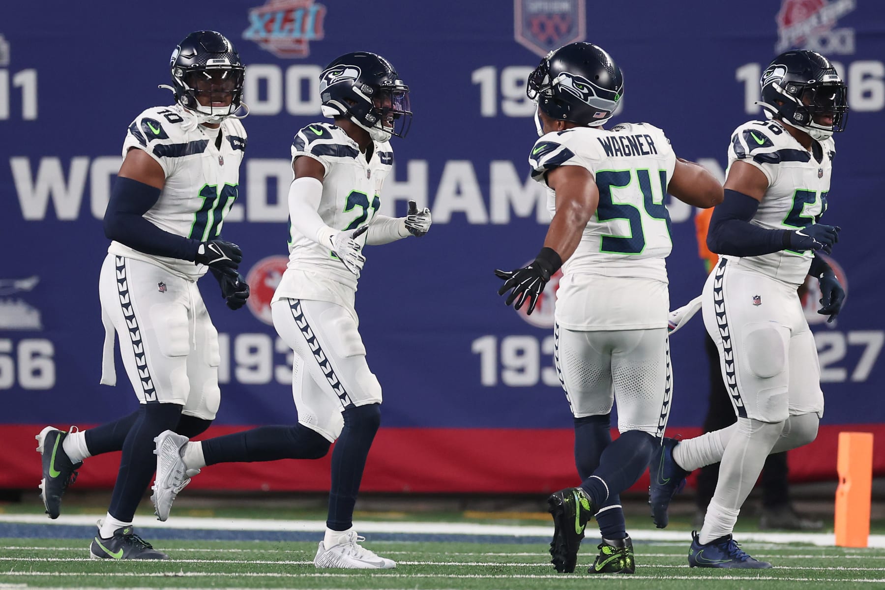 EAST RUTHERFORD, NEW JERSEY - OCTOBER 02: Devon Witherspoon #21 of the Seattle Seahawks celebrates his interception return for a touchdown with teammates during the third quarter against the New York Giants at MetLife Stadium on October 02, 2023 in East Rutherford, New Jersey. (Photo by Al Bello/Getty Images)