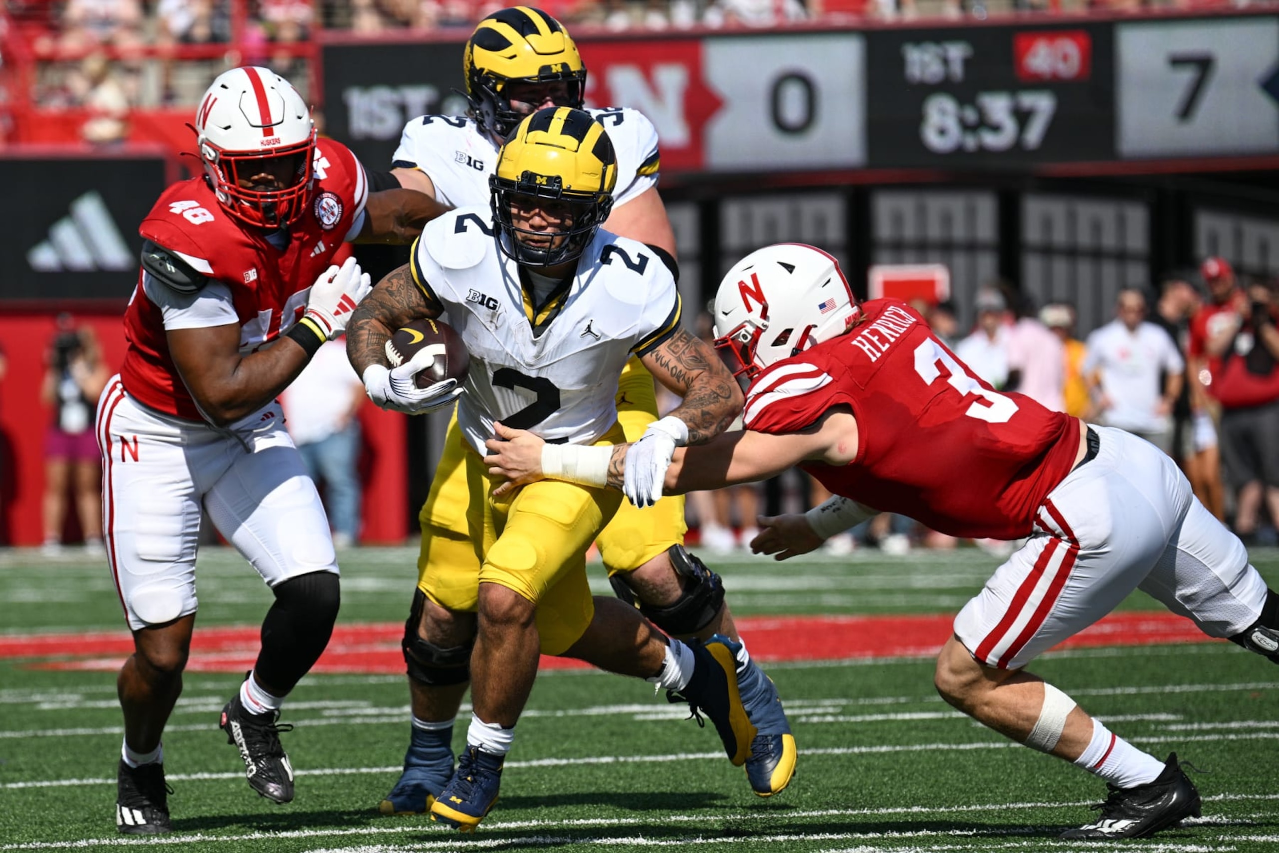 LINCOLN, NEBRASKA - SEPTEMBER 30: Blake Corum #2 of the Michigan Wolverines breaks a tackle of Nick Henrich #3 of the Nebraska Cornhuskers in the first quarter at Memorial Stadium on September 30, 2023 in Lincoln, Nebraska. (Photo by Steven Branscombe/Getty Images) LINCOLN, NEBRASKA - SEPTEMBER 30: Blake Corum #2 of the Michigan Wolverines breaks a tackle of Nick Henrich #3 of the Nebraska Cornhuskers in the first quarter at Memorial Stadium on September 30, 2023 in Lincoln, Nebraska. (Photo by Steven Branscombe/Getty Images)