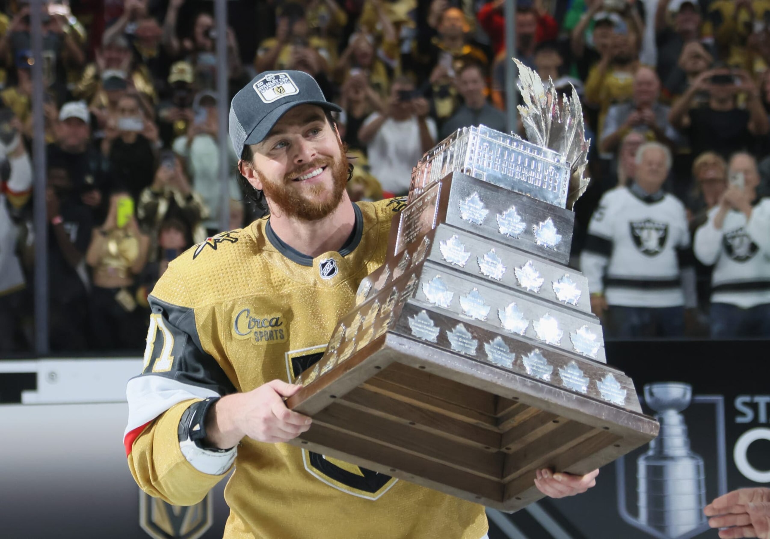 Vegas Golden Knights winger Jonathan Marchessault posing with the Conn Smythe Trophy as the 2023 playoff MVP.