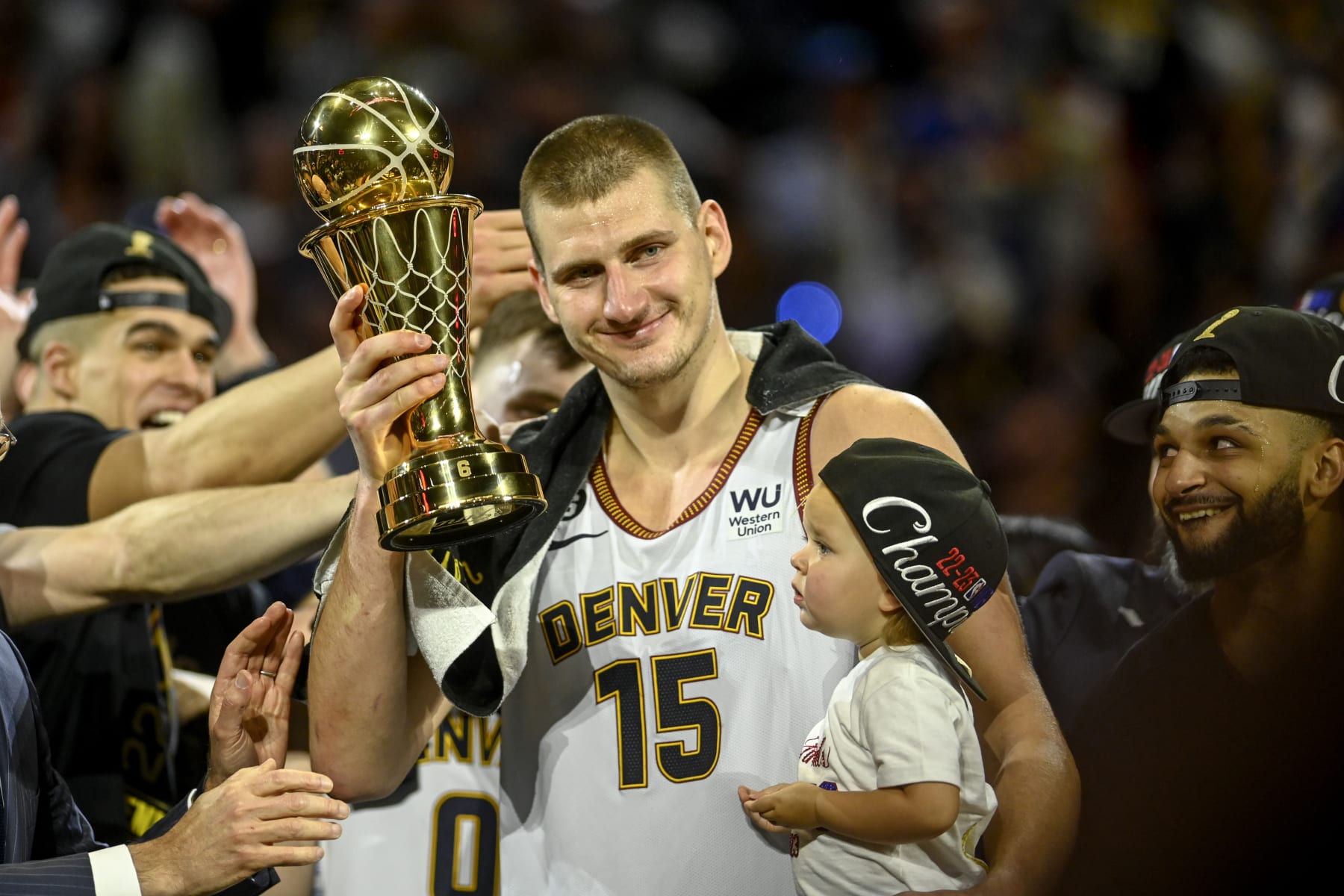 DENVER, CO - JUNE 12: Nikola Jokic (15) of the Denver Nuggets displays the NBA Finals Most Valuable Player Award as the star holds his daughter, Ognjena, after the fourth quarter of the Nuggets' 94-89 NBA Finals clinching win over the Miami Heat at Ball Arena in Denver on Monday, June 12, 2023. (Photo by AAron Ontiveroz/The Denver Post)