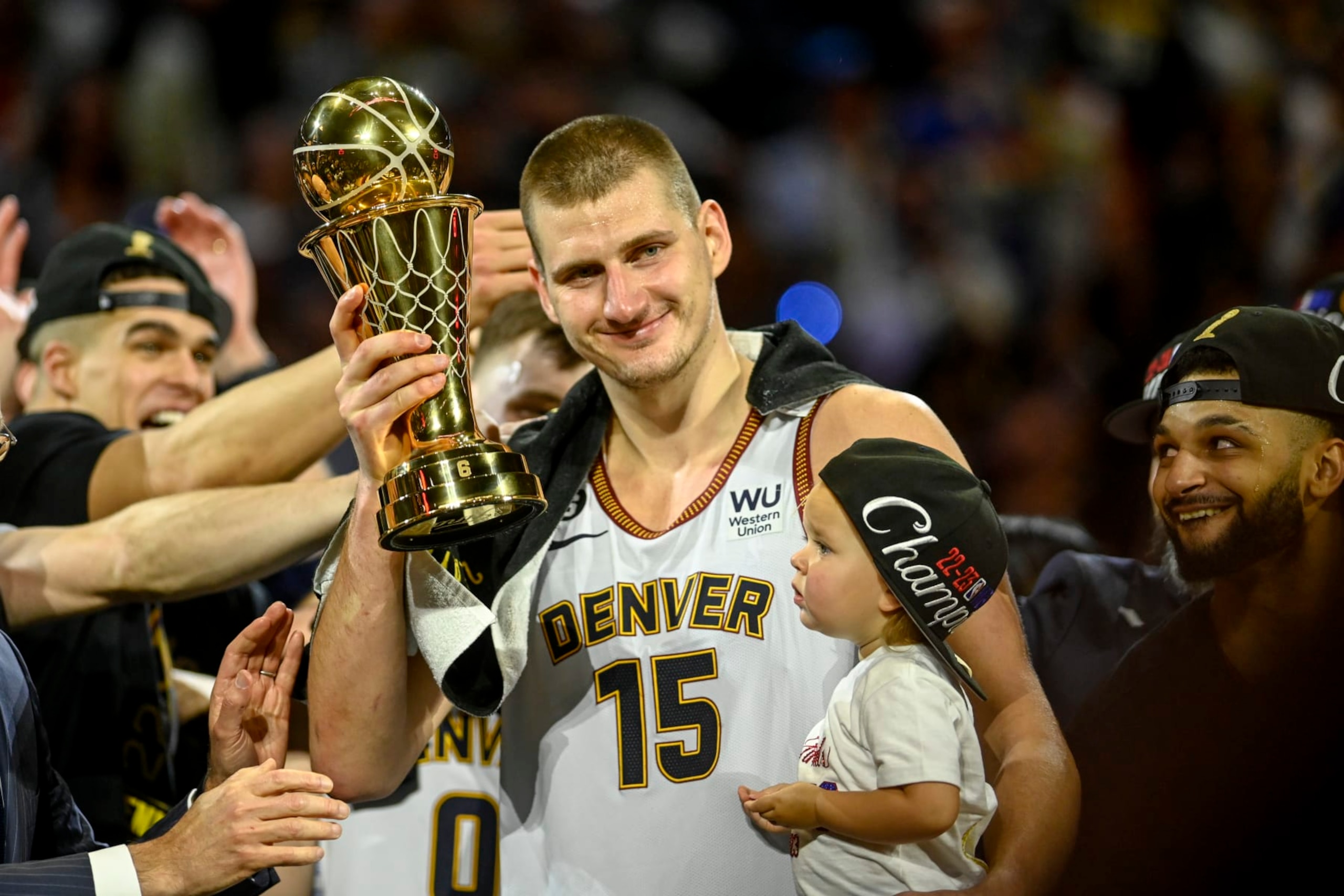 DENVER, CO - JUNE 12: Nikola Jokic (15) of the Denver Nuggets displays the NBA Finals Most Valuable Player Award as the star holds his daughter, Ognjena, after the fourth quarter of the Nuggets' 94-89 NBA Finals clinching win over the Miami Heat at Ball Arena in Denver on Monday, June 12, 2023. (Photo by AAron Ontiveroz/The Denver Post)