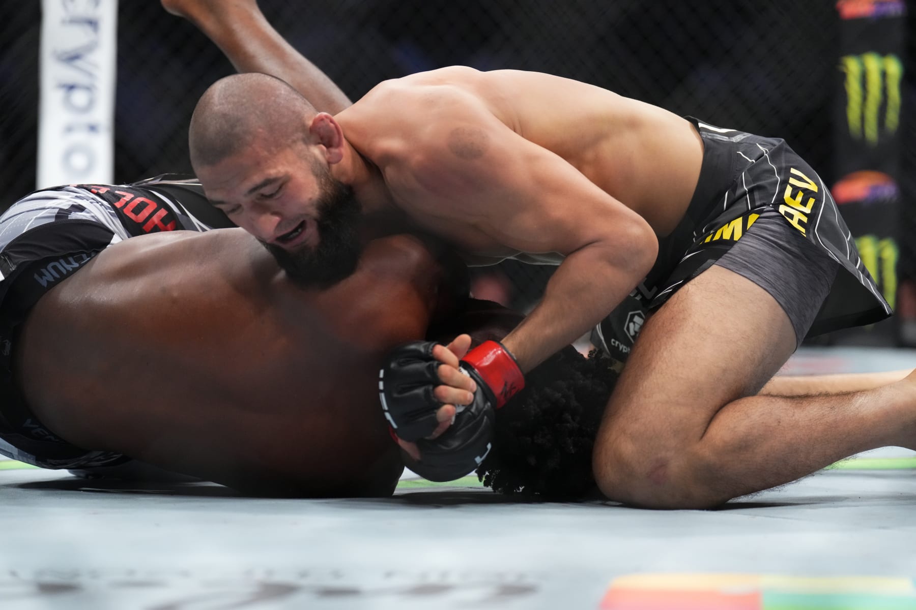 Khamzat Chimaev sets up a D'arce choke against Kevin Holland.