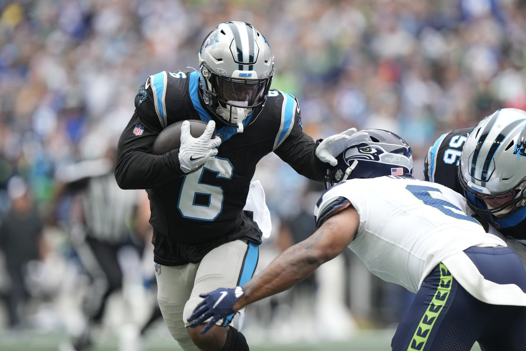 SEATTLE, WASHINGTON - SEPTEMBER 24: Miles Sanders #6 of the Carolina Panthers stiff arms Quandre Diggs #6 of the Seattle Seahawks during the first quarter at Lumen Field on September 24, 2023 in Seattle, Washington. (Photo by Christopher Mast/Getty Images)