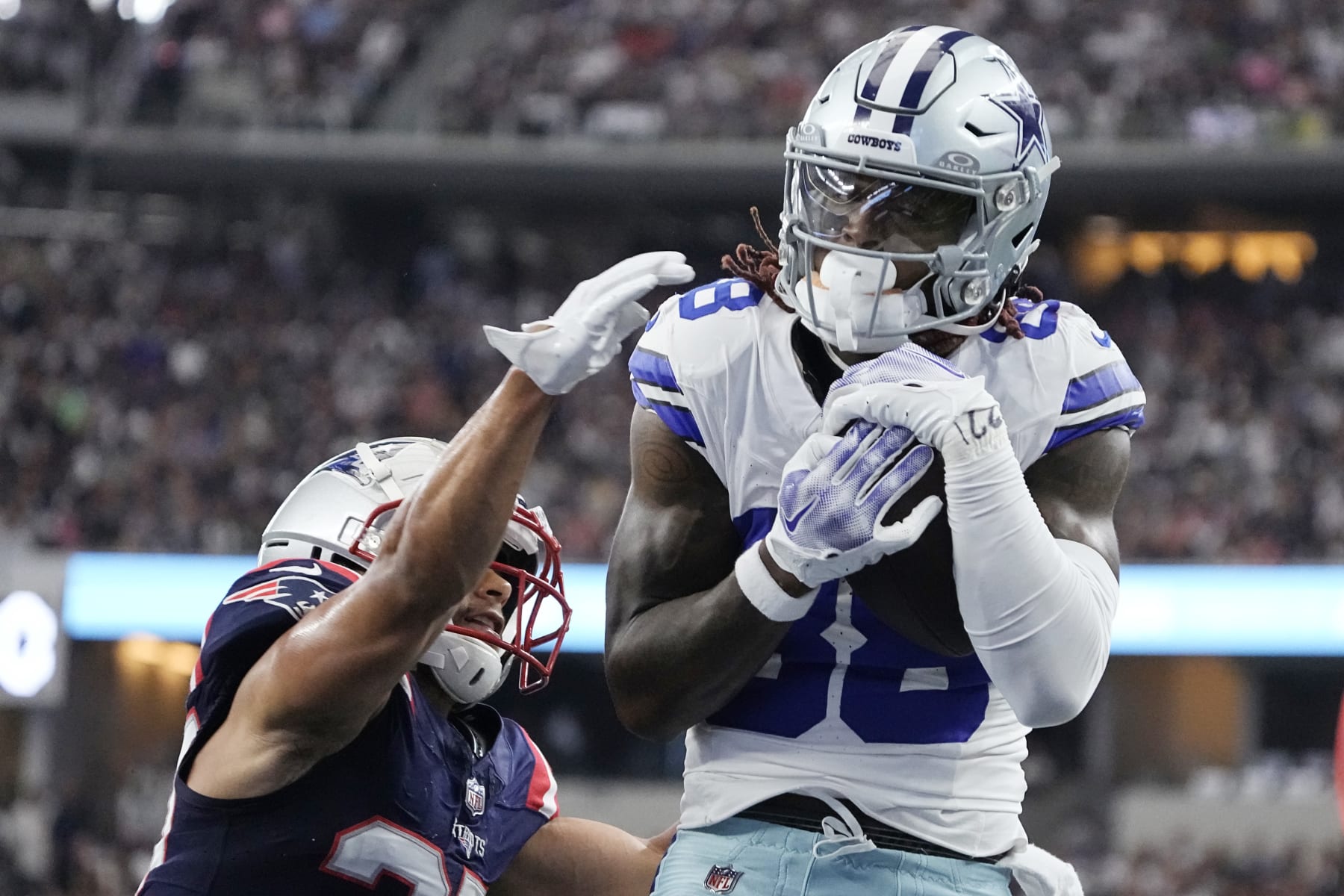 ARLINGTON, TEXAS - OCTOBER 01: CeeDee Lamb #88 of the Dallas Cowboys catches a touchdown over Myles Bryant #27 of the New England Patriots during the first quarter at AT&T Stadium on October 01, 2023 in Arlington, Texas. (Photo by Sam Hodde/Getty Images)