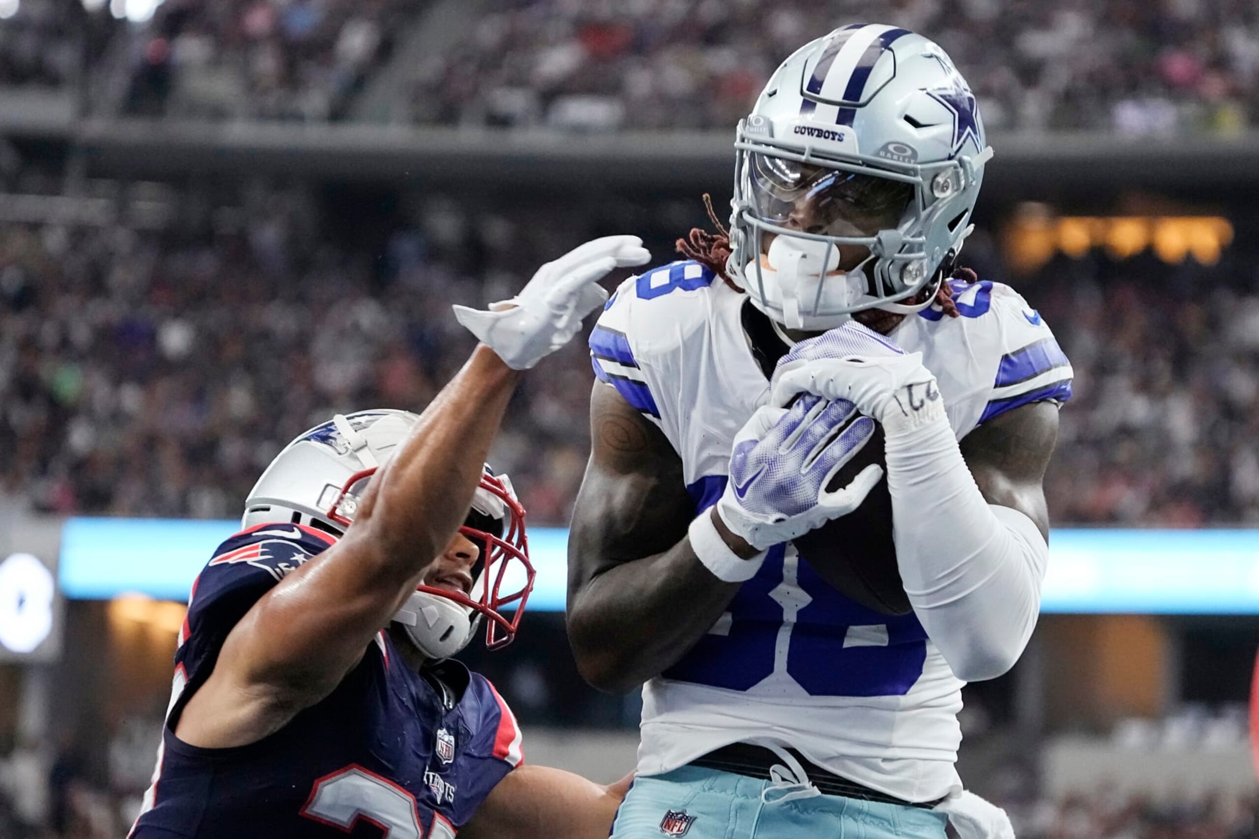 ARLINGTON, TEXAS - OCTOBER 01: CeeDee Lamb #88 of the Dallas Cowboys catches a touchdown over Myles Bryant #27 of the New England Patriots during the first quarter at AT&T Stadium on October 01, 2023 in Arlington, Texas. (Photo by Sam Hodde/Getty Images)