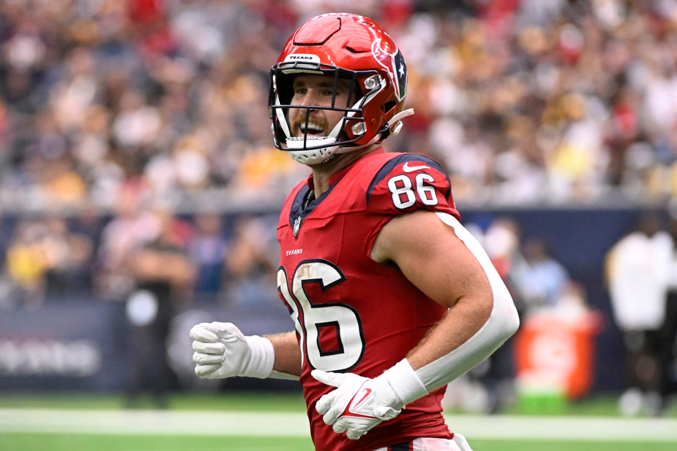 HOUSTON, TEXAS - OCTOBER 01: Dalton Schultz #86 of the Houston Texans reacts after catching a pass for a touchdown against the Pittsburgh Steelers during the fourth quarter at NRG Stadium on October 01, 2023 in Houston, Texas. (Photo by Logan Riely/Getty Images)