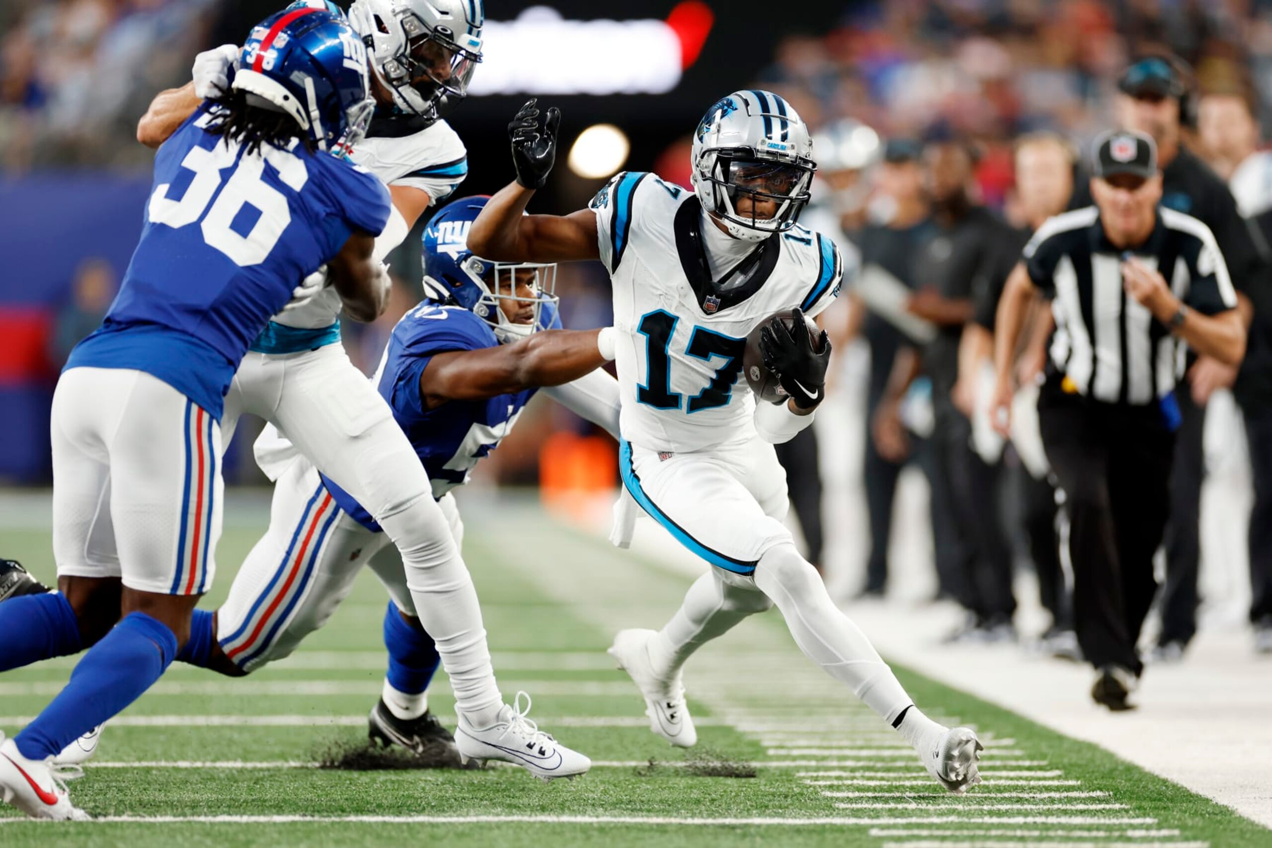 EAST RUTHERFORD, NEW JERSEY - AUGUST 18: DJ Chark Jr. #17 of the Carolina Panthers carries the ball as Bobby Okereke #58 of the New York Giants defends during the first half of a preseason game at MetLife Stadium on August 18, 2023 in East Rutherford, New Jersey. (Photo by Sarah Stier/Getty Images)