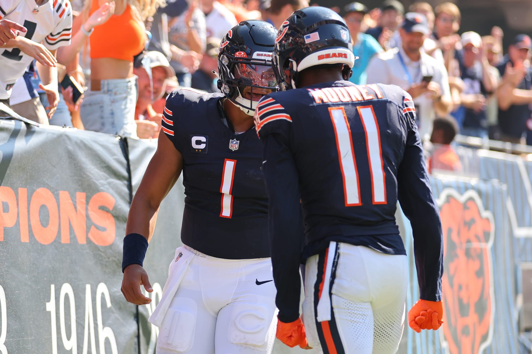 CHICAGO, ILLINOIS - OCTOBER 01: Justin Fields #1 and Darnell Mooney #11 of the Chicago Bears celebrate a touchdown against the Denver Broncos during the second quarter at Soldier Field on October 01, 2023 in Chicago, Illinois. (Photo by Michael Reaves/Getty Images)