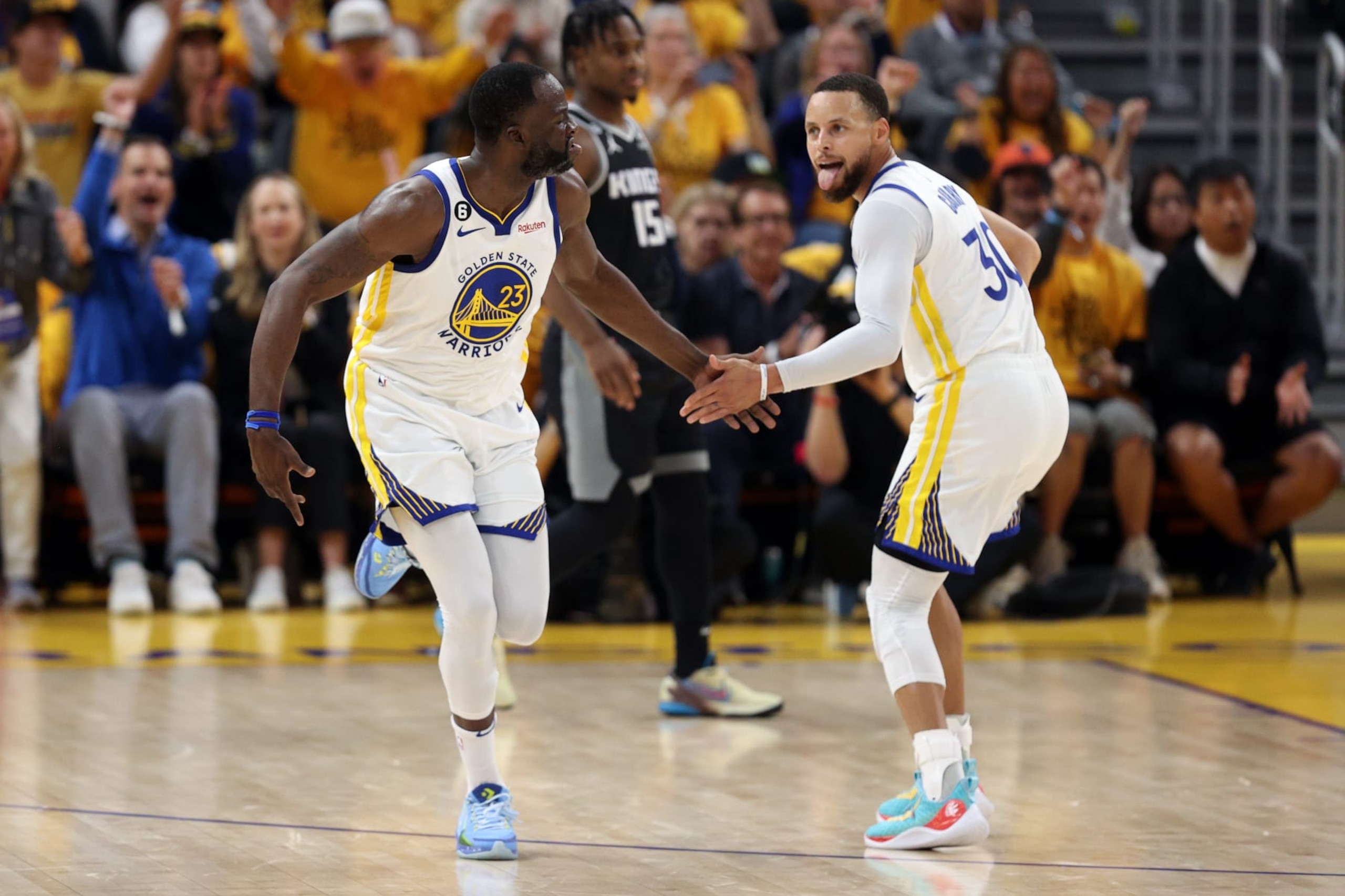 SAN FRANCISCO, CALIFORNIA - APRIL 23: Stephen Curry #30 congratulates Draymond Green #23 of the Golden State Warriors after he made a basket against the Sacramento Kings during Game Four of the Western Conference First Round Playoffs at Chase Center on April 23, 2023 in San Francisco, California. NOTE TO USER: User expressly acknowledges and agrees that, by downloading and or using this photograph, User is consenting to the terms and conditions of the Getty Images License Agreement. (Photo by Ezra Shaw/Getty Images)