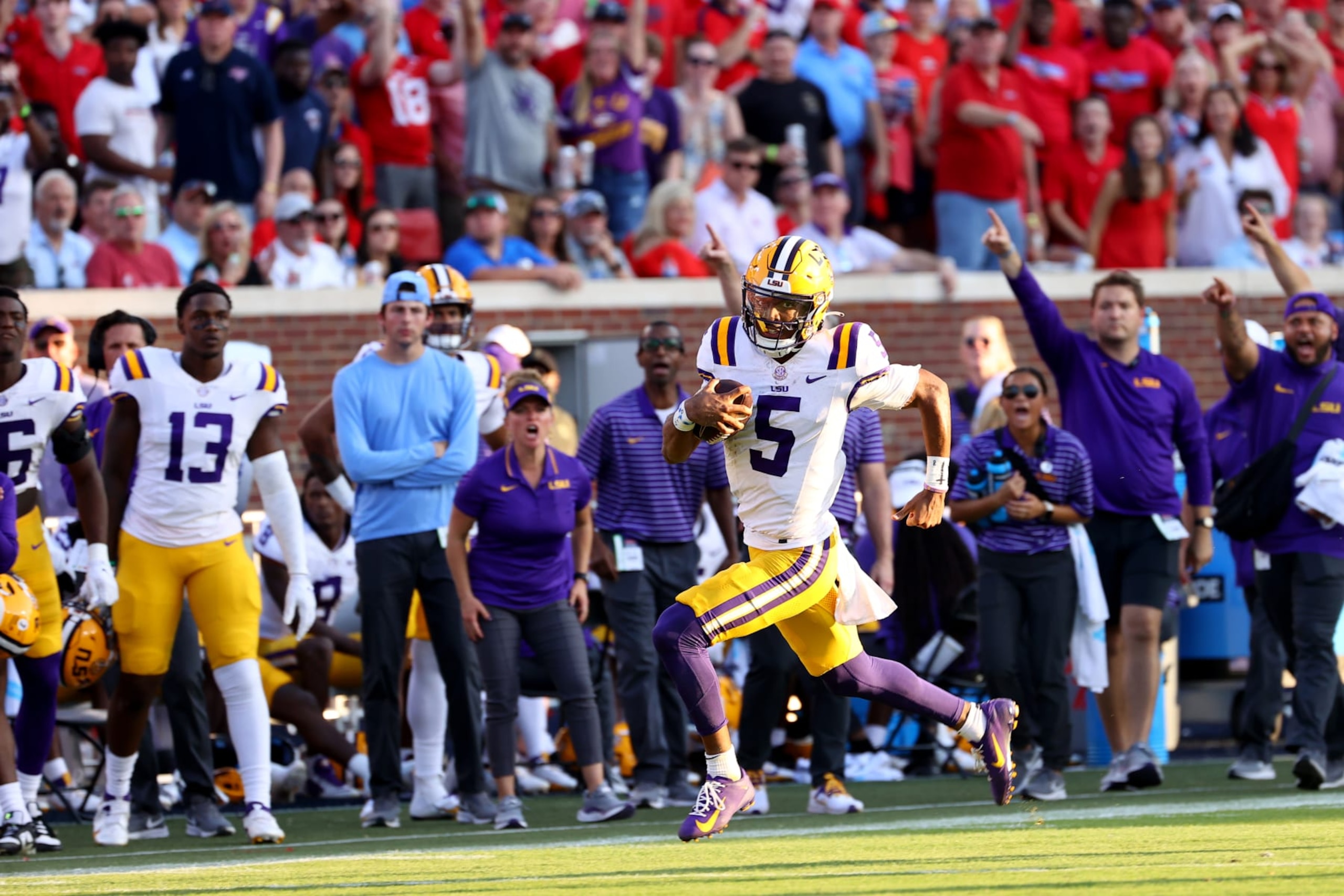OXFORD, MISSISSIPPI - SEPTEMBER 30: Jayden Daniels #5 of the LSU Tigers rushes against the Mississippi Rebels in the first half at Vaught-Hemingway Stadium on September 30, 2023 in Oxford, Mississippi. (Photo by Jamie Schwaberow/Getty Images)