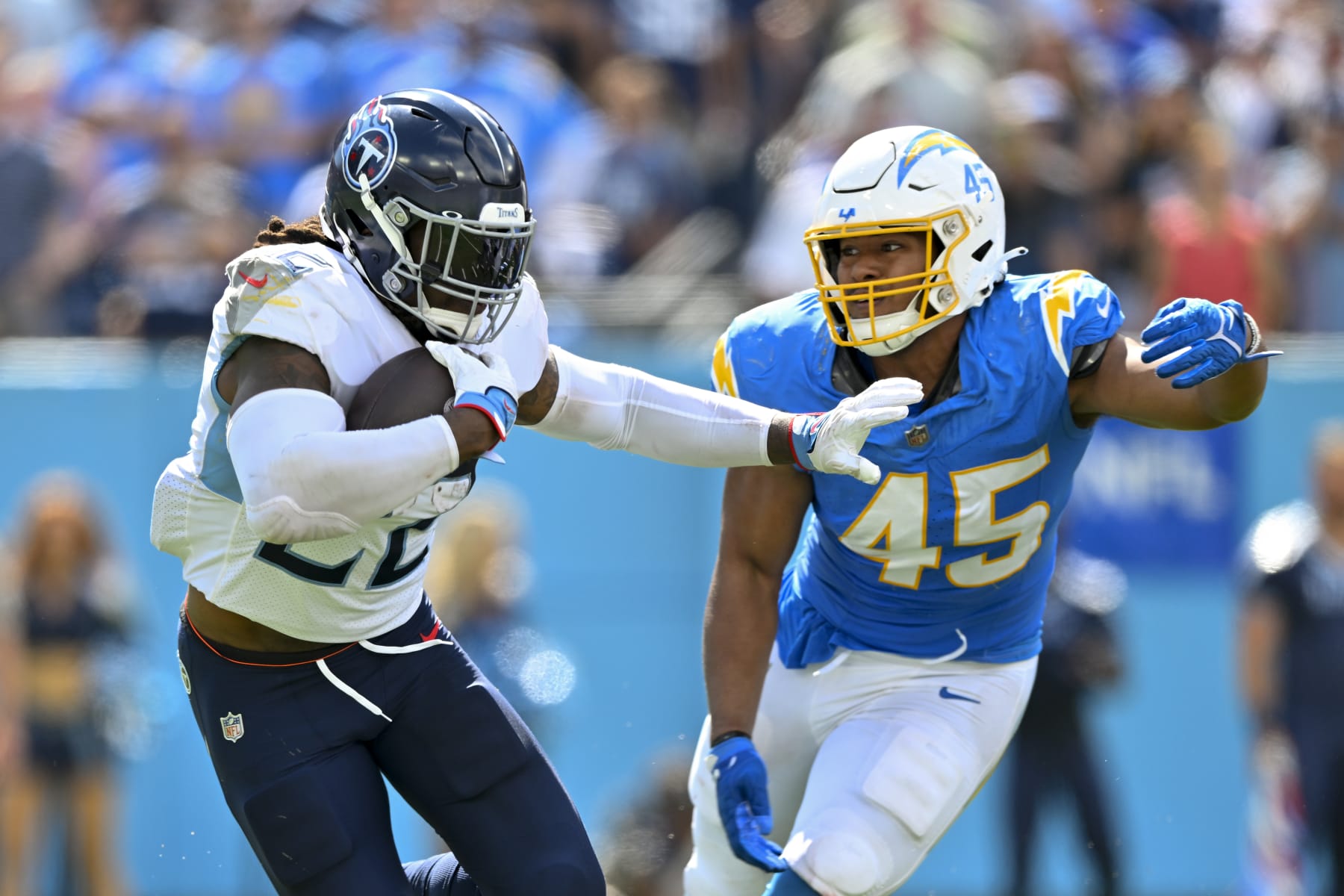 NASHVILLE, TENNESSEE - SEPTEMBER 17: Derrick Henry #22 of the Tennessee Titans runs the ball against Tuli Tuipulotu #45 of the Los Angeles Chargers during an NFL football game at Nissan Stadium on September 17, 2023 in Nashville, Tennessee. The Tennessee Titans won 27-24 in overtime. (Photo by Alika Jenner/Getty Images)