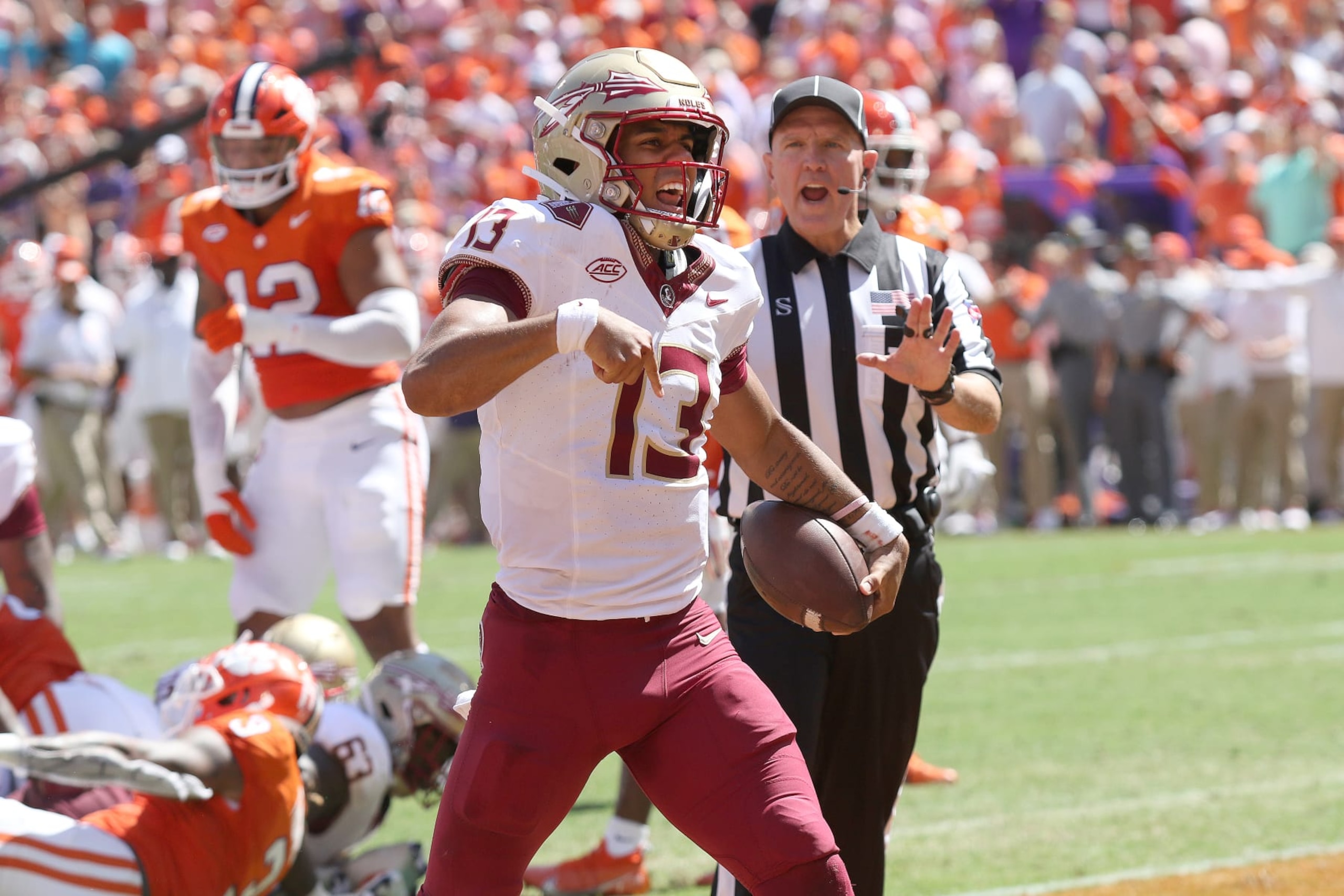 CLEMSON, SC - SEPTEMBER 23: Florida State Seminoles quarterback Jordan Travis (13)  celebrates scoring a touchdown during a college football game between the Florida State Seminoles and the Clemson Tigers on September 23, 2023, at Clemson Memorial Stadium in Clemson, S.C.  (Photo by John Byrum/Icon Sportswire via Getty Images)
