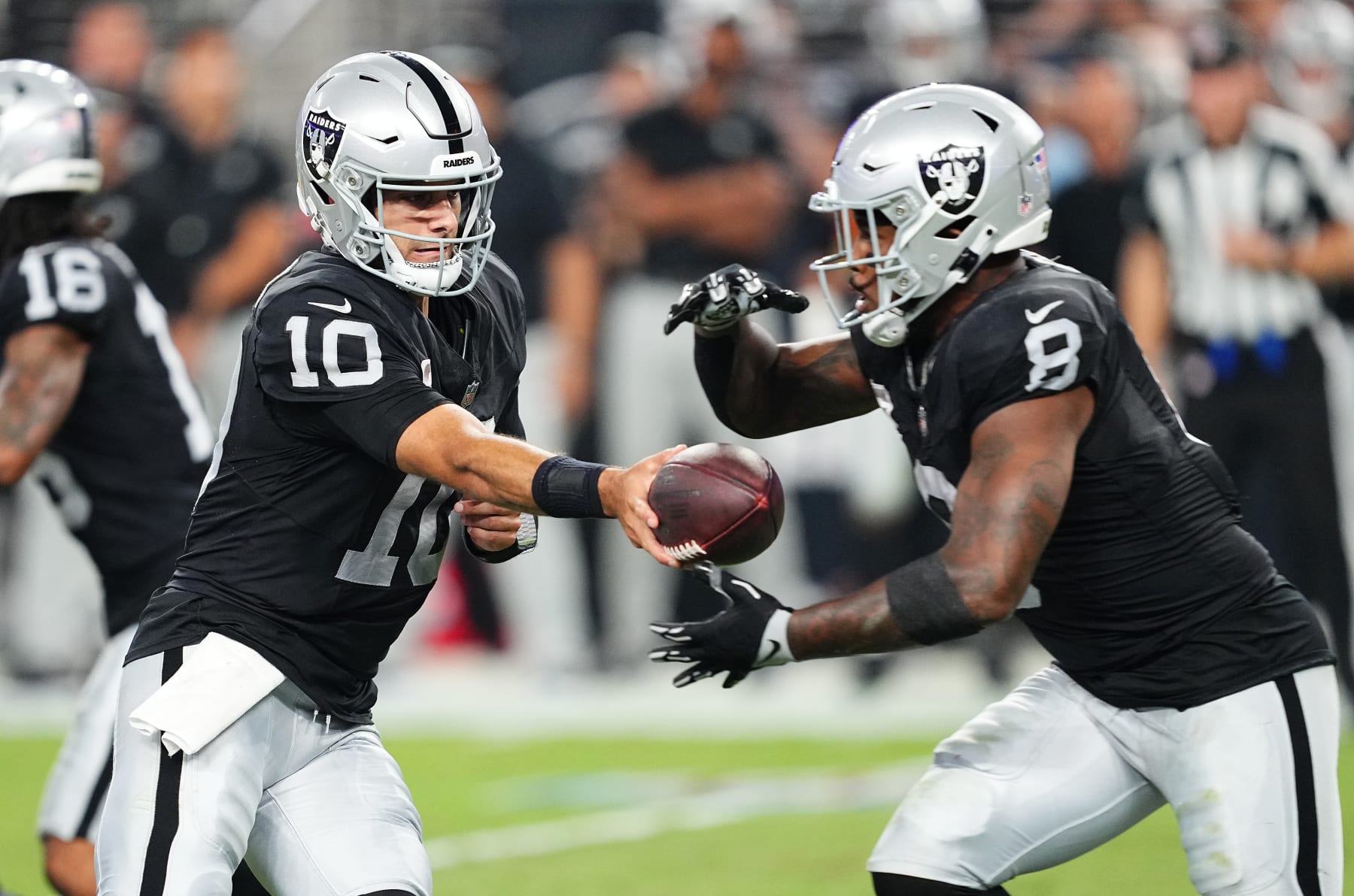 LAS VEGAS, NEVADA - SEPTEMBER 24: Jimmy Garoppolo #10 of the Las Vegas Raiders hands the ball off to Josh Jacobs #8  during the second quarter at Allegiant Stadium on September 24, 2023 in Las Vegas, Nevada. (Photo by Chris Unger/Getty Images)