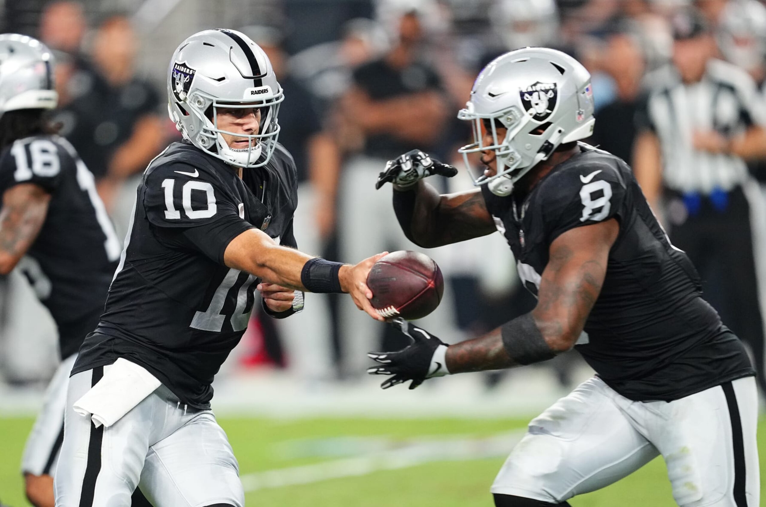 LAS VEGAS, NEVADA - SEPTEMBER 24: Jimmy Garoppolo #10 of the Las Vegas Raiders hands the ball off to Josh Jacobs #8  during the second quarter at Allegiant Stadium on September 24, 2023 in Las Vegas, Nevada. (Photo by Chris Unger/Getty Images)