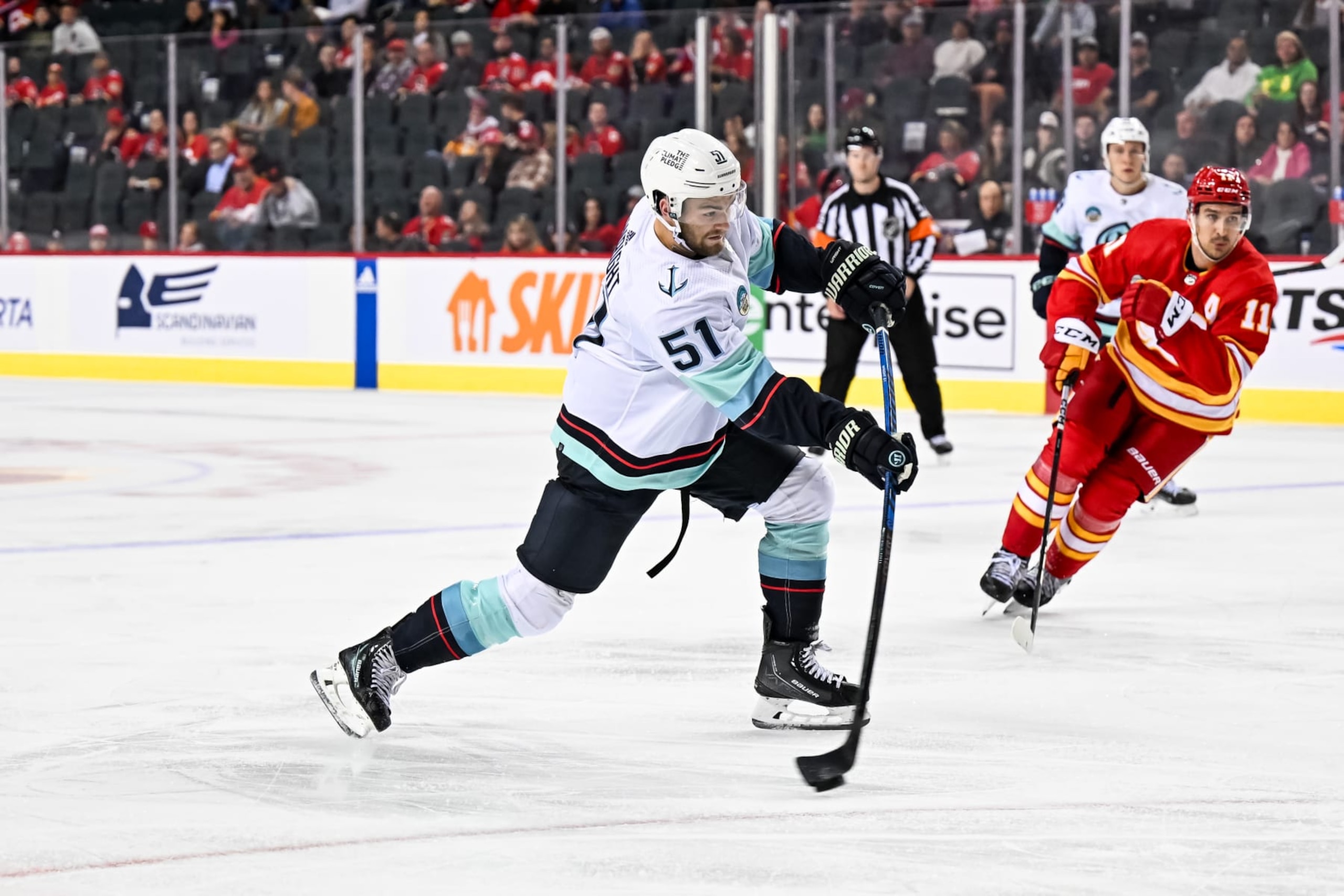 CALGARY, AB - SEPTEMBER 25: Seattle Kraken Center Shane Wright (51) takes a shot during the second period of an NHL preseason game between the Calgary Flames and the Seattle Kraken on September 25, 2023, at the Scotiabank Saddledome in Calgary, AB. (Photo by Brett Holmes/Icon Sportswire via Getty Images)