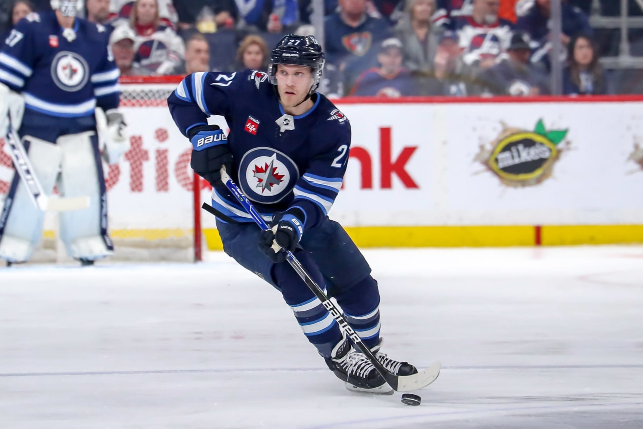 WINNIPEG, CANADA - APRIL 10: Nikolaj Ehlers #27 of the Winnipeg Jets plays the puck up the ice during second period action against the San Jose Sharks at the Canada Life Centre on April 10, 2023 in Winnipeg, Manitoba, Canada. The Jets defeated the Sharks 6-2. (Photo by Darcy Finley/NHLI via Getty Images)