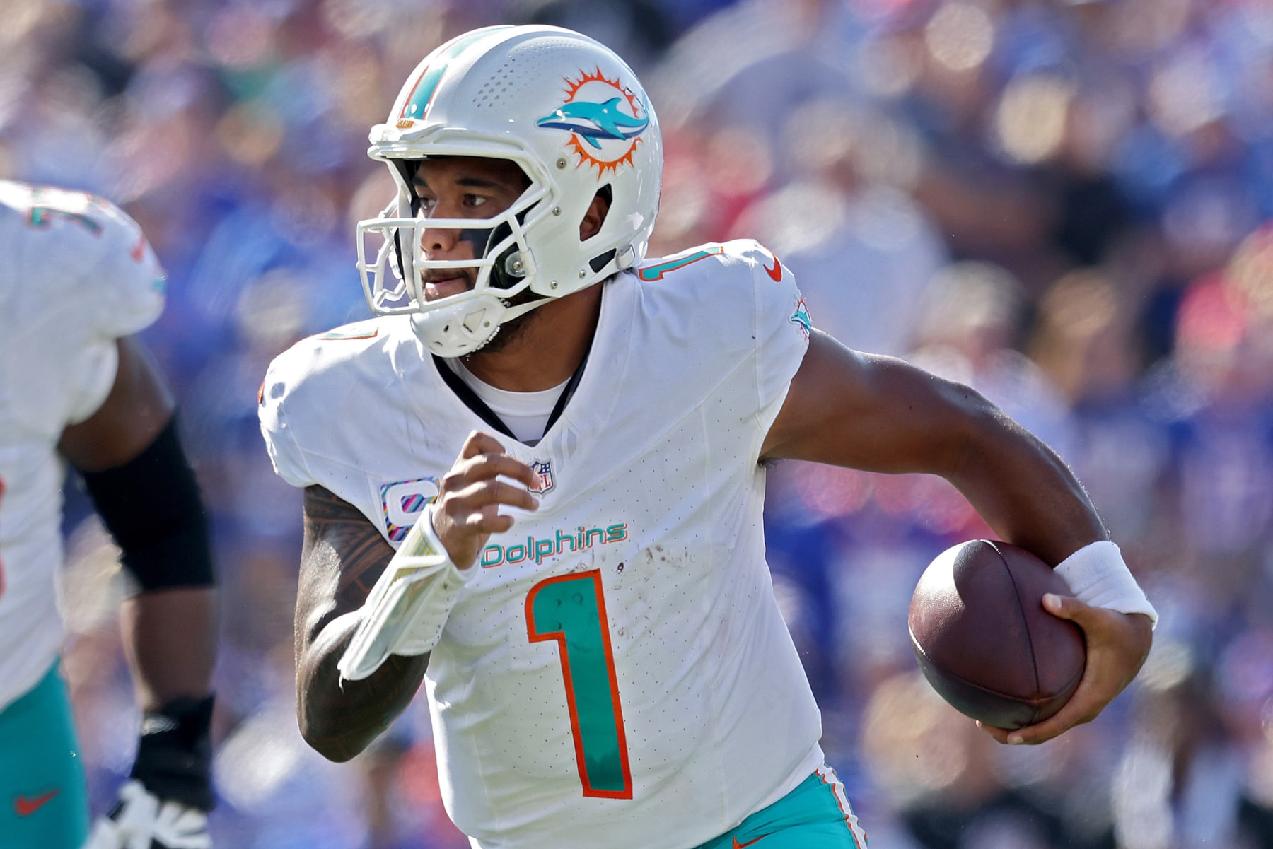 ORCHARD PARK, NEW YORK - OCTOBER 01: Tua Tagovailoa #1 of the Miami Dolphins runs during the third quarter against the Buffalo Bills at Highmark Stadium on October 01, 2023 in Orchard Park, New York. (Photo by Bryan Bennett/Getty Images)