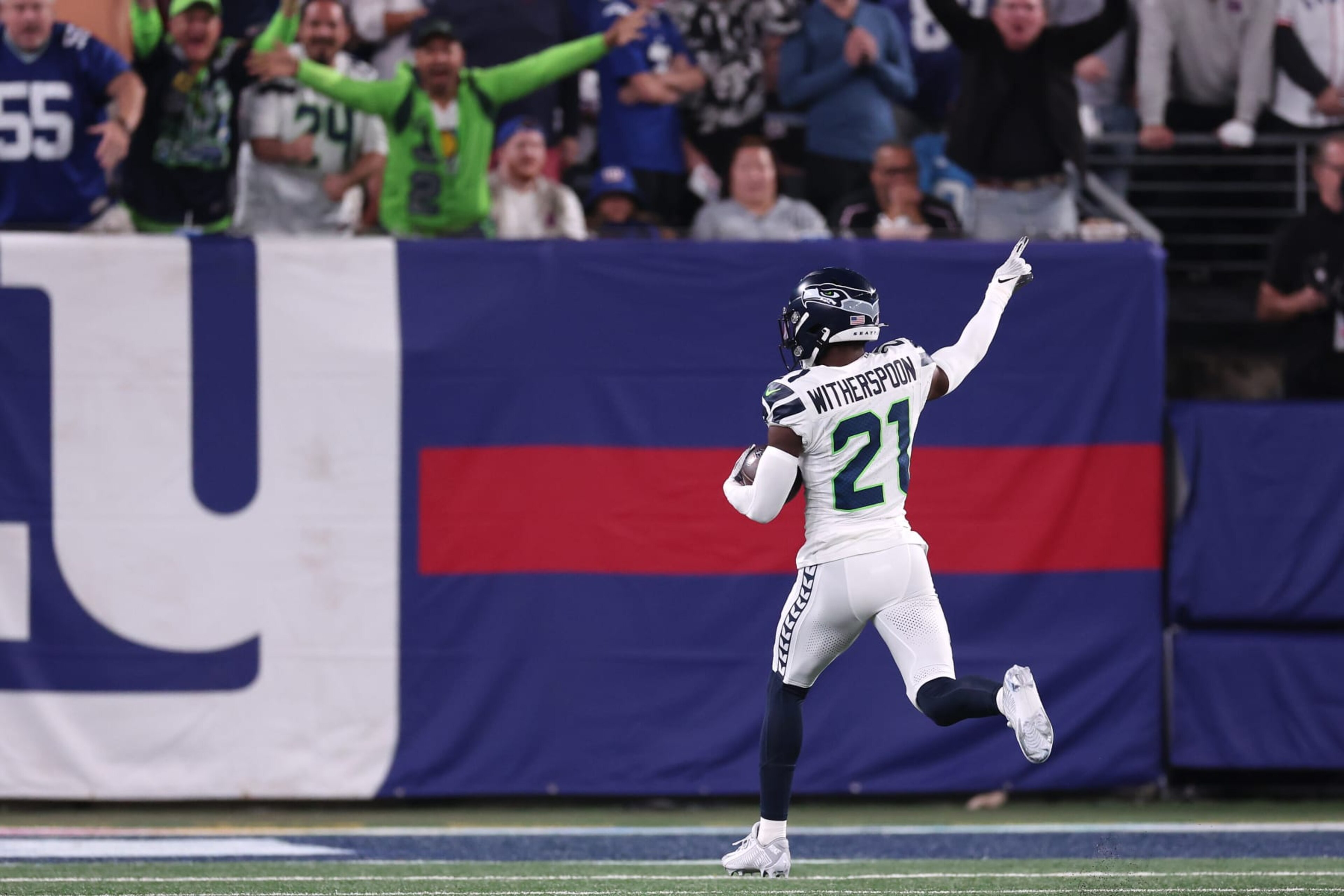 EAST RUTHERFORD, NEW JERSEY - OCTOBER 02: Devon Witherspoon #21 of the Seattle Seahawks returns an interception 97-yards for a touchdown during the third quarter against the New York Giants at MetLife Stadium on October 02, 2023 in East Rutherford, New Jersey. (Photo by Al Bello/Getty Images)