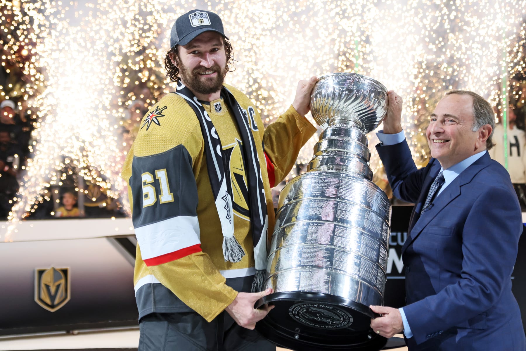 Mark Stone (left) holds the Stanley Cup alongside NHL Commissioner Gary Bettman