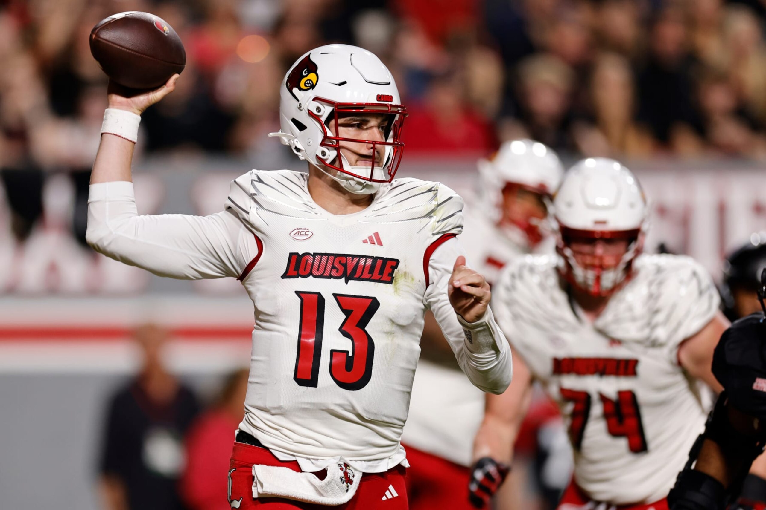 RALEIGH, NORTH CAROLINA - SEPTEMBER 29: Jack Plummer #13 of the Louisville Cardinals drops back to pass against the NC State Wolfpack during the first half at Carter-Finley Stadium on September 29, 2023 in Raleigh, North Carolina. (Photo by Lance King/Getty Images)