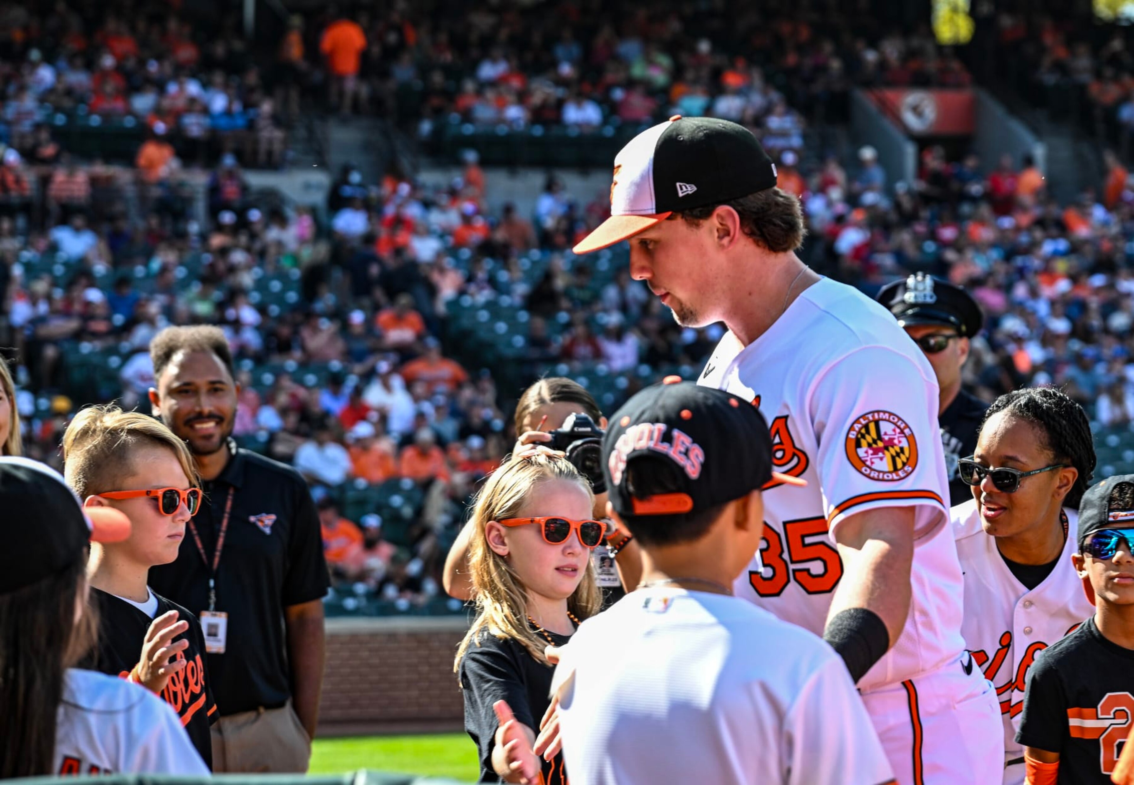 BALTIMORE, MD - October 01: Baltimore Orioles designated hitter Adley Rutschman (35) walks through a throng of children on the way to the dugout prior to the Boston Red Sox versus the Baltimore Orioles on October 1, 2023 at Oriole Park at Camden Yards in Baltimore, MD. (Photo by Mark Goldman/Icon Sportswire via Getty Images) BALTIMORE, MD - October 01: Baltimore Orioles designated hitter Adley Rutschman (35) walks through a throng of children on the way to the dugout prior to the Boston Red Sox versus the Baltimore Orioles on October 1, 2023 at Oriole Park at Camden Yards in Baltimore, MD. (Photo by Mark Goldman/Icon Sportswire via Getty Images)