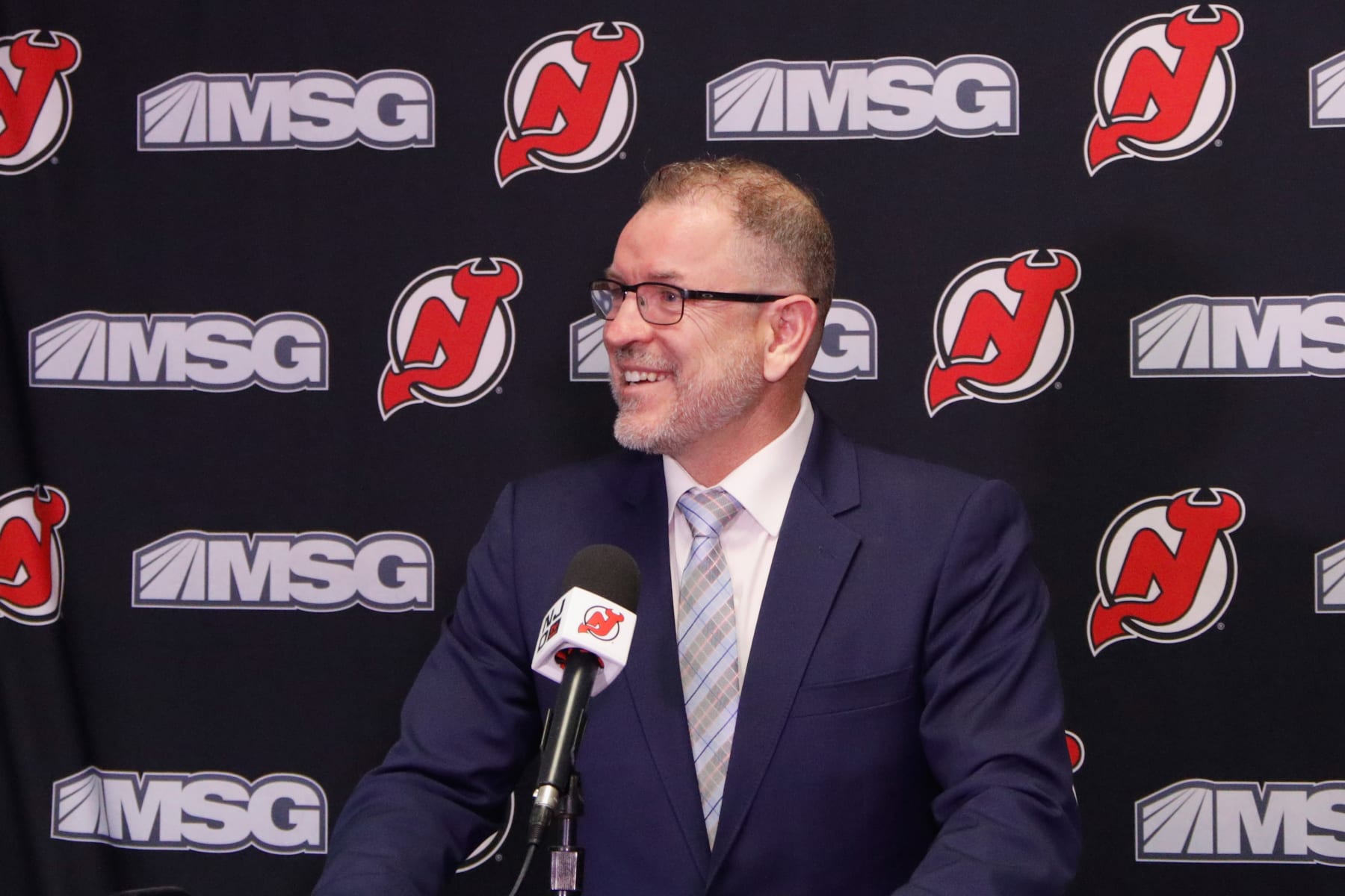 NEWARK, NEW JERSEY - NOVEMBER 30: General manager Tom Fitzgerald of the New Jersey Devils announces a contract extension for Jack Hughes prior to the game against the San Jose Sharks at the Prudential Center on November 30, 2021 in Newark, New Jersey. (Photo by Bruce Bennett/Getty Images)