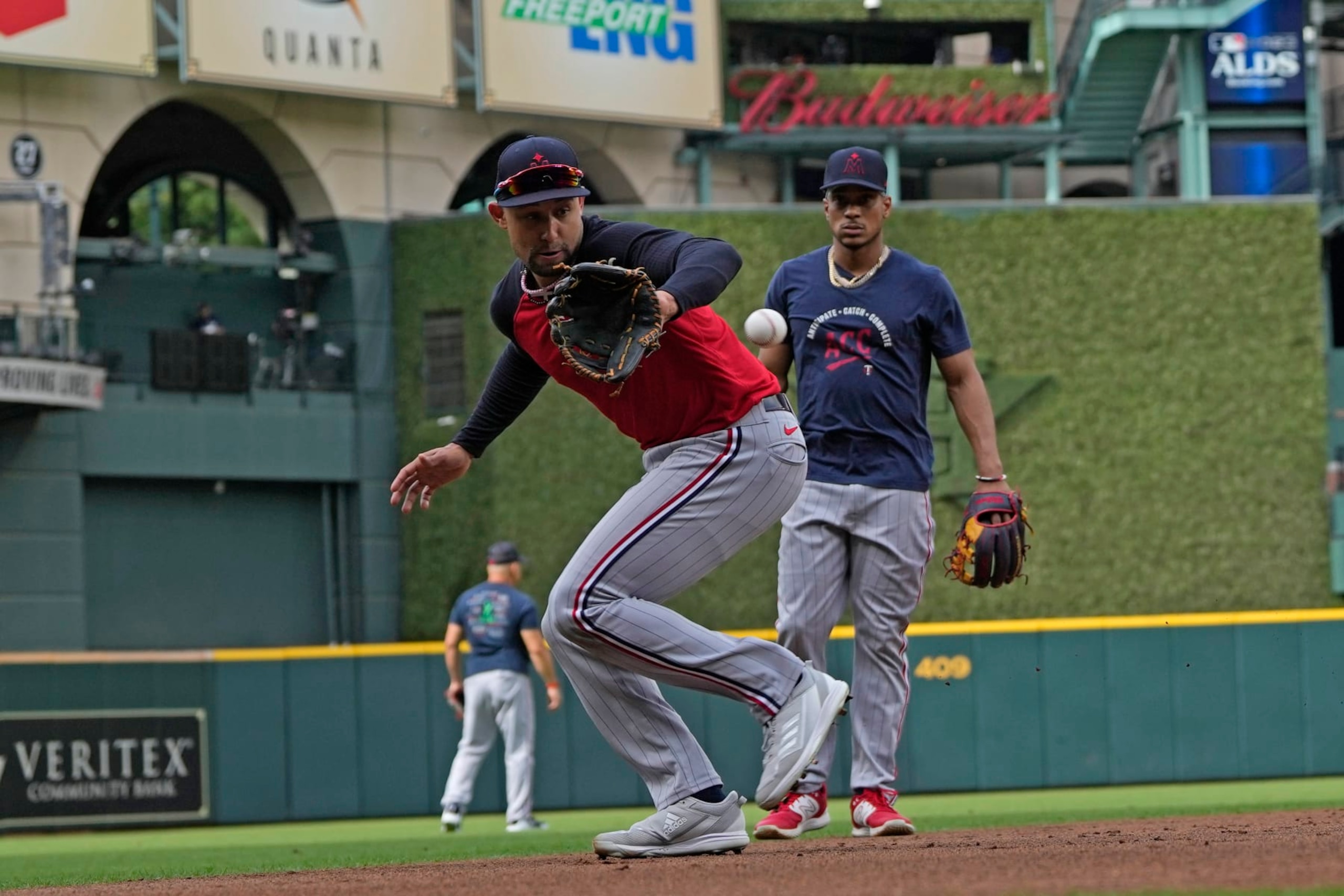 Minnesota Twins' Royce Lewis, front, fields a ground ball during an ALDS baseball workout Friday, Oct. 6, 2023, in Houston. The Twins will play the Houston Astros in Game 1 of an ALDS series Saturday. (AP Photo/David J. Phillip)