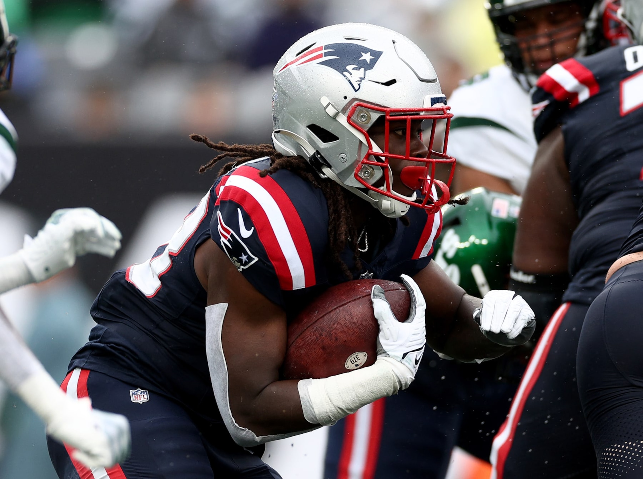 EAST RUTHERFORD, NEW JERSEY - SEPTEMBER 24: Rhamondre Stevenson #38 of the New England Patriots carries the ball against the New York Jets at MetLife Stadium on September 24, 2023 in East Rutherford, New Jersey. (Photo by Elsa/Getty Images)