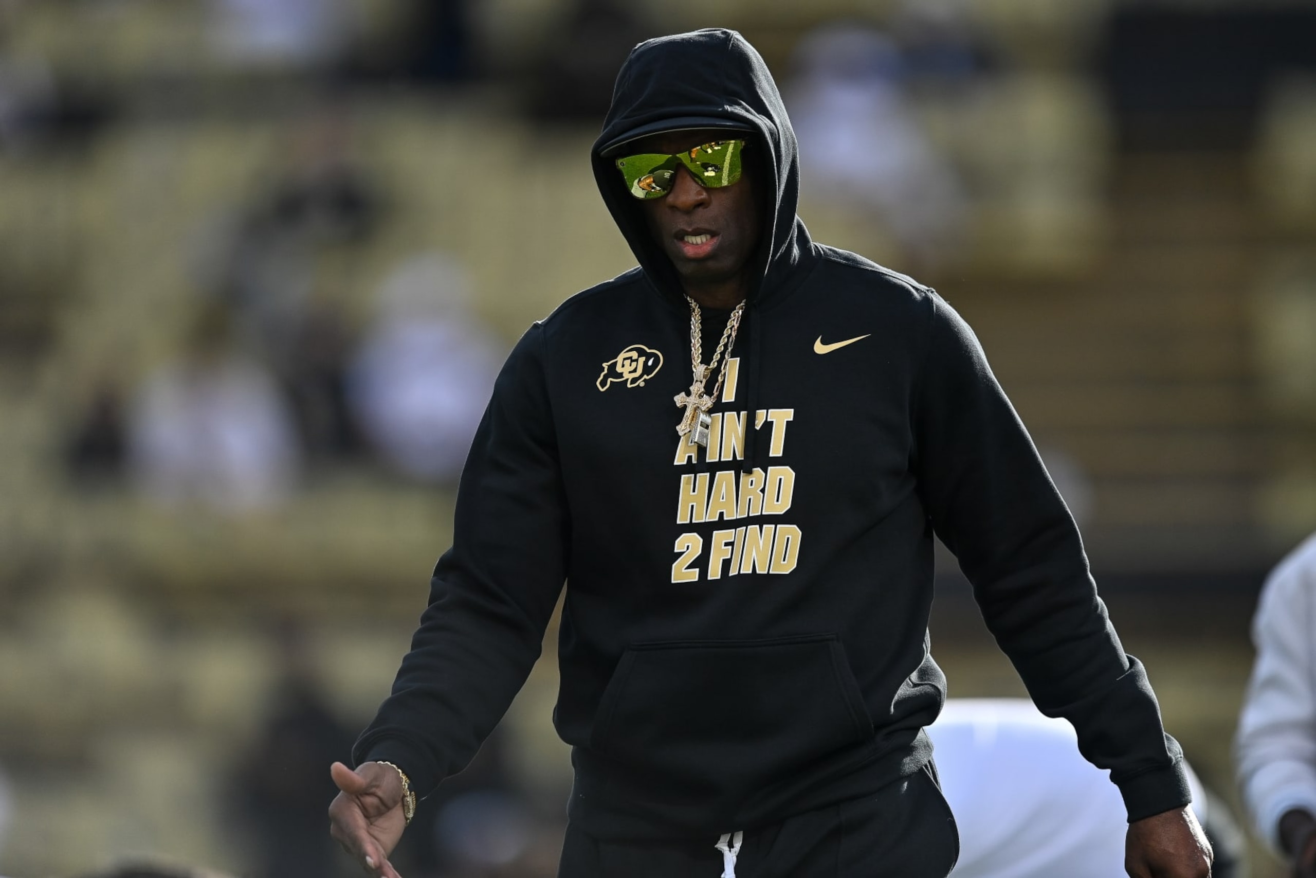 BOULDER, CO - SEPTEMBER 30: Head coach Deion Sanders of the Colorado Buffaloes walks on the field to greet players as they stretch before a game against the USC Trojans at Folsom Field on September 30, 2023 in Boulder, Colorado. (Photo by Dustin Bradford/Getty Images) BOULDER, CO - SEPTEMBER 30: Head coach Deion Sanders of the Colorado Buffaloes walks on the field to greet players as they stretch before a game against the USC Trojans at Folsom Field on September 30, 2023 in Boulder, Colorado. (Photo by Dustin Bradford/Getty Images)