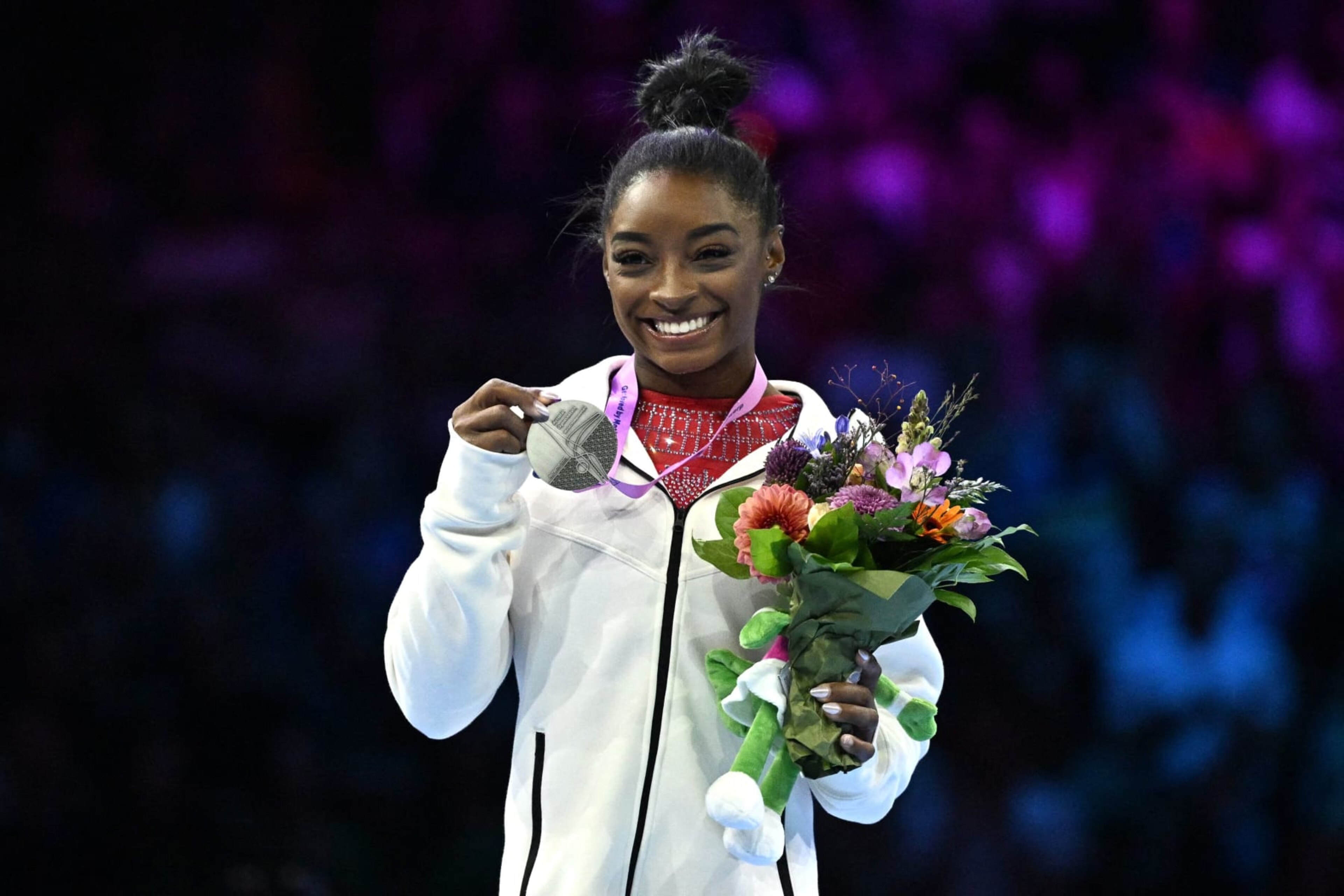 Second-placed US' Simone Biles celebrates on the podium after the Women's Vault Final during the 52nd FIG Artistic Gymnastics World Championships, in Antwerp, northern Belgium, on October 7, 2023. (Photo by Lionel BONAVENTURE / AFP) (Photo by LIONEL BONAVENTURE/AFP via Getty Images) Second-placed US' Simone Biles celebrates on the podium after the Women's Vault Final during the 52nd FIG Artistic Gymnastics World Championships, in Antwerp, northern Belgium, on October 7, 2023. (Photo by Lionel BONAVENTURE / AFP) (Photo by LIONEL BONAVENTURE/AFP via Getty Images)