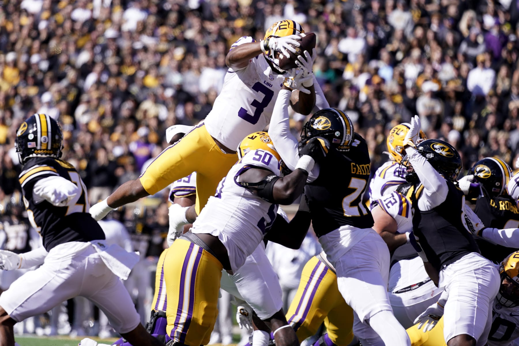 COLUMBIA, MISSOURI - OCTOBER 07: Running back Logan Diggs #3 of the LSU Tigers leaps into the endzone for a touchdown against the Missouri Tigers in the first half at Faurot Field/Memorial Stadium on October 07, 2023 in Columbia, Missouri. (Photo by Ed Zurga/Getty Images)